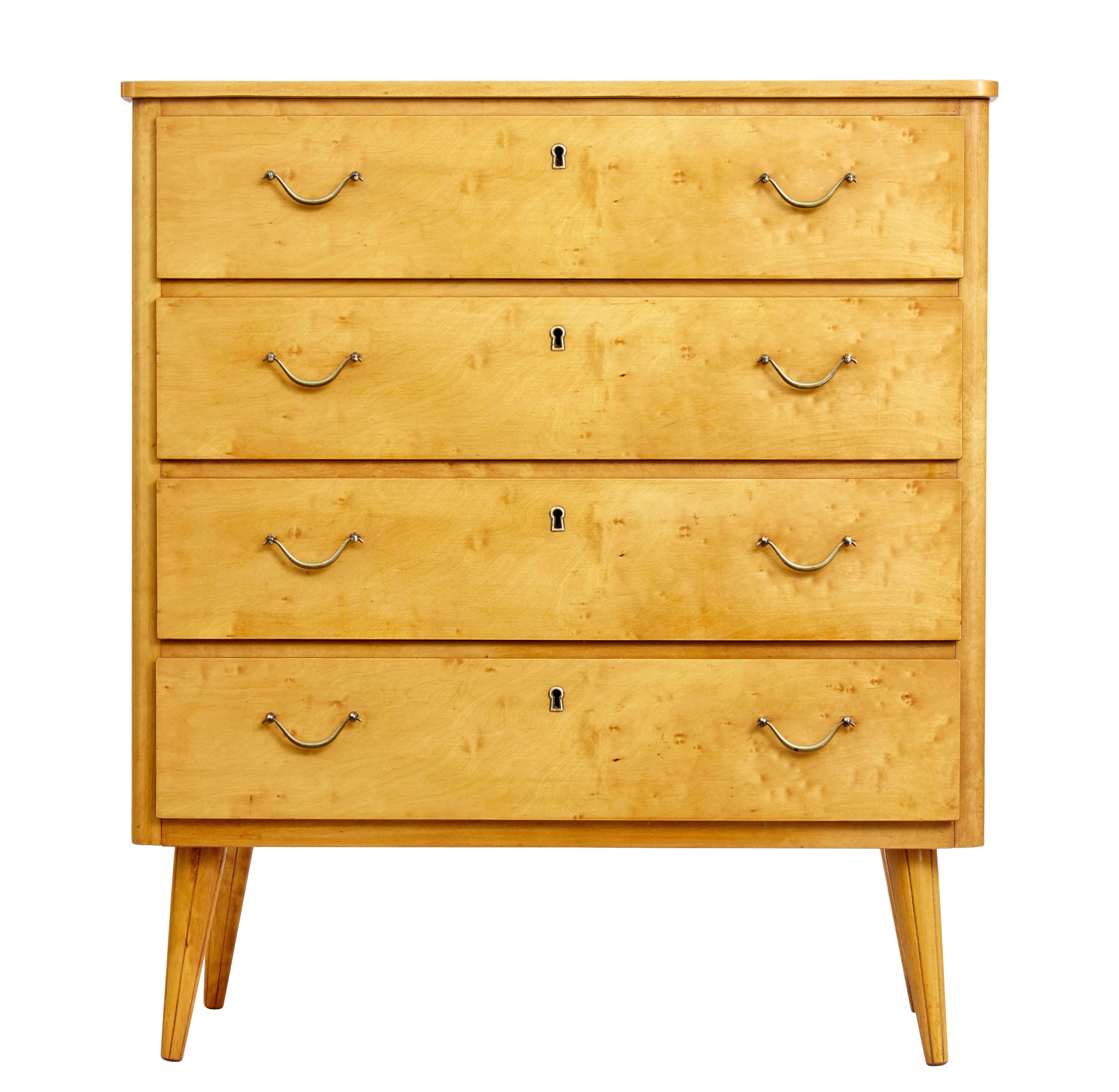 Four drawer chest of drawers from Sweden, circa 1950.

Drawers fitted with brass modern swan neck handles. Rich golden color.

Standing on tapered legs.

Some polish loss to top surface, but perfectly usable.