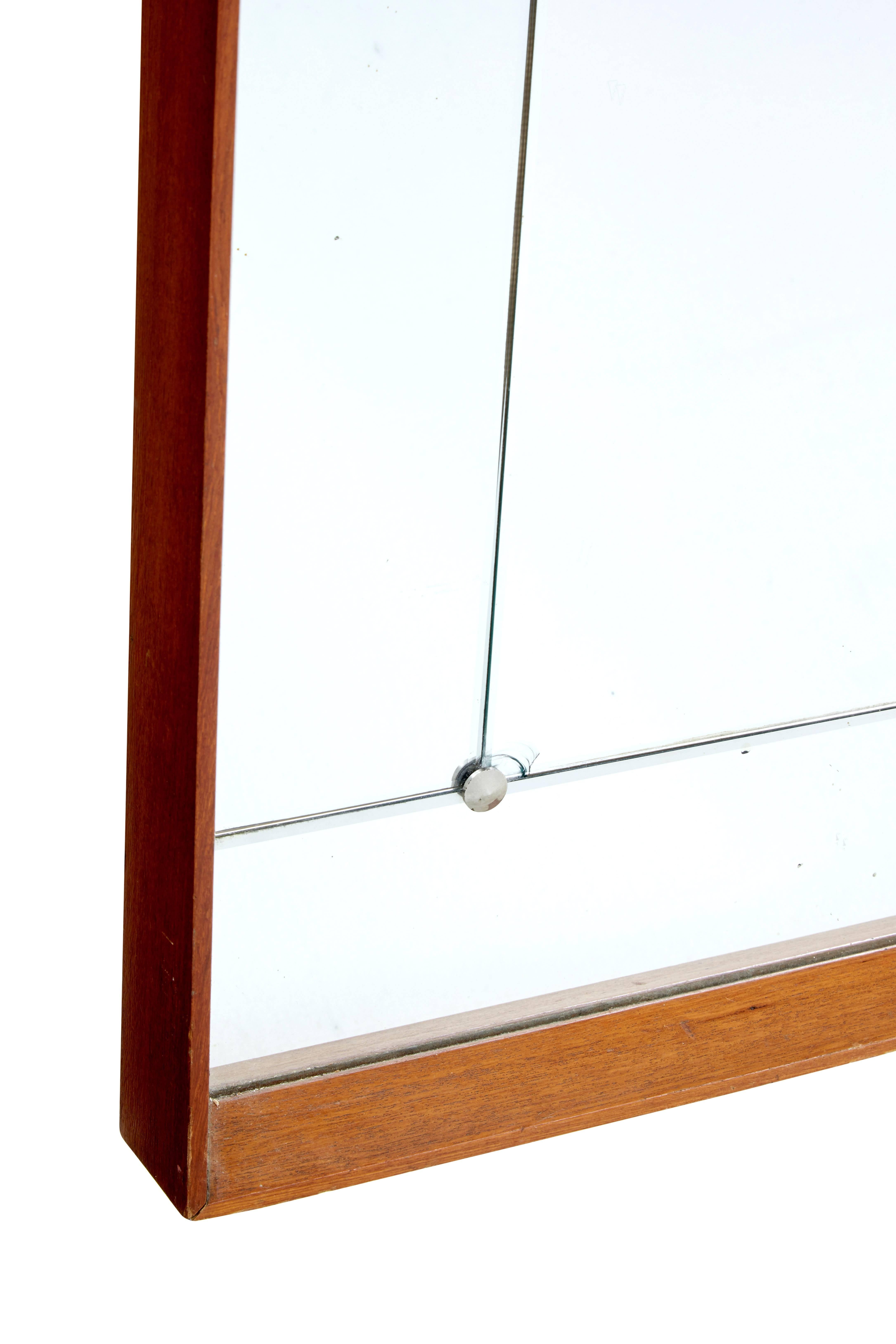 Scandinavian large wall mirror, circa 1950.

Bevelled teak frame, with central mirror surrounded by mirrored panels held in place by screw studs.

One small area of plate loss and one small chip which is photographed.