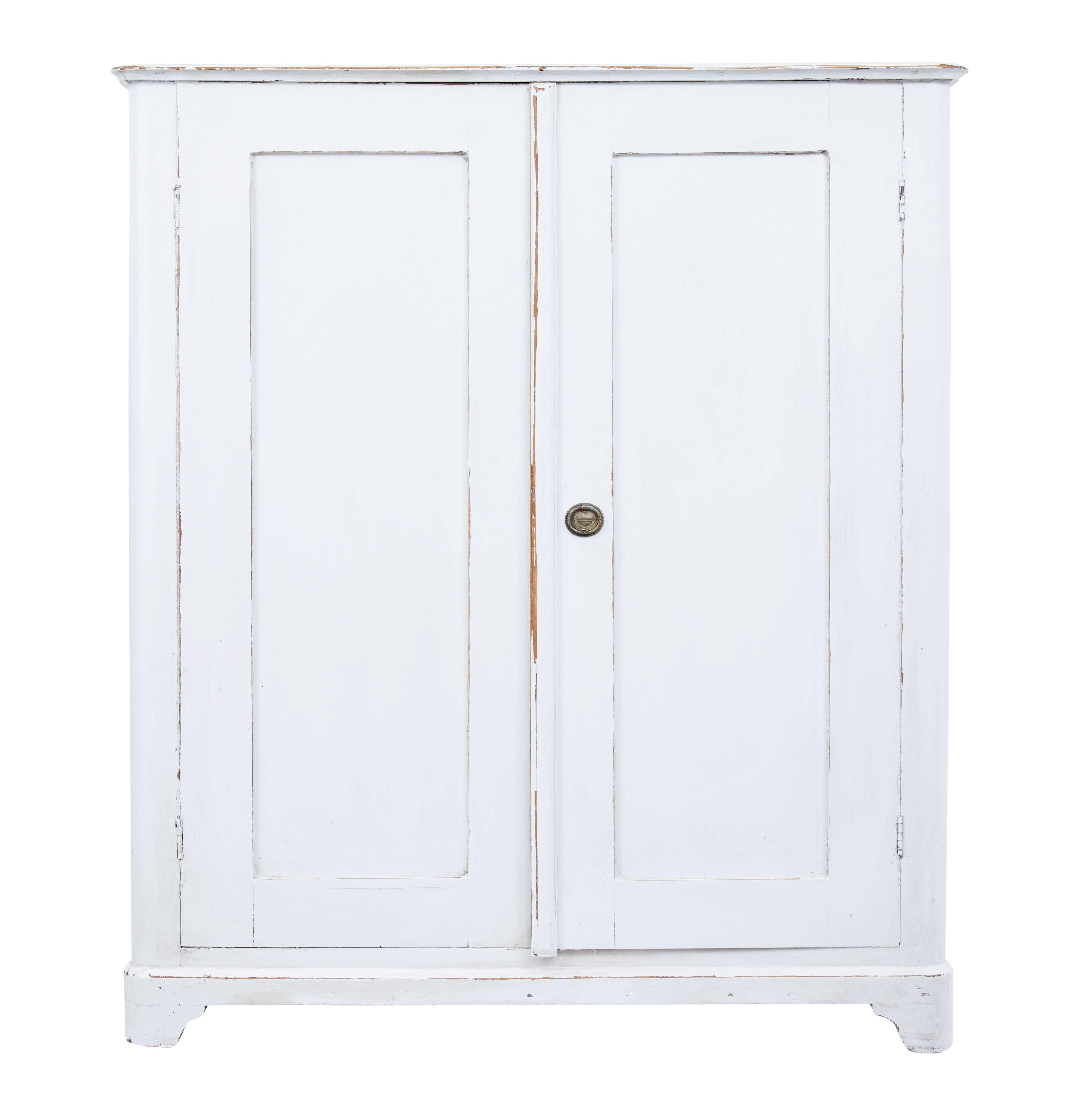 Practical piece of rustic furniture, circa 1880.

Later painted in an off white color which is showing signs of wear.

Double doors open to a partially fitted interior, three drawers to the top and an open slot where the fourth drawer would have