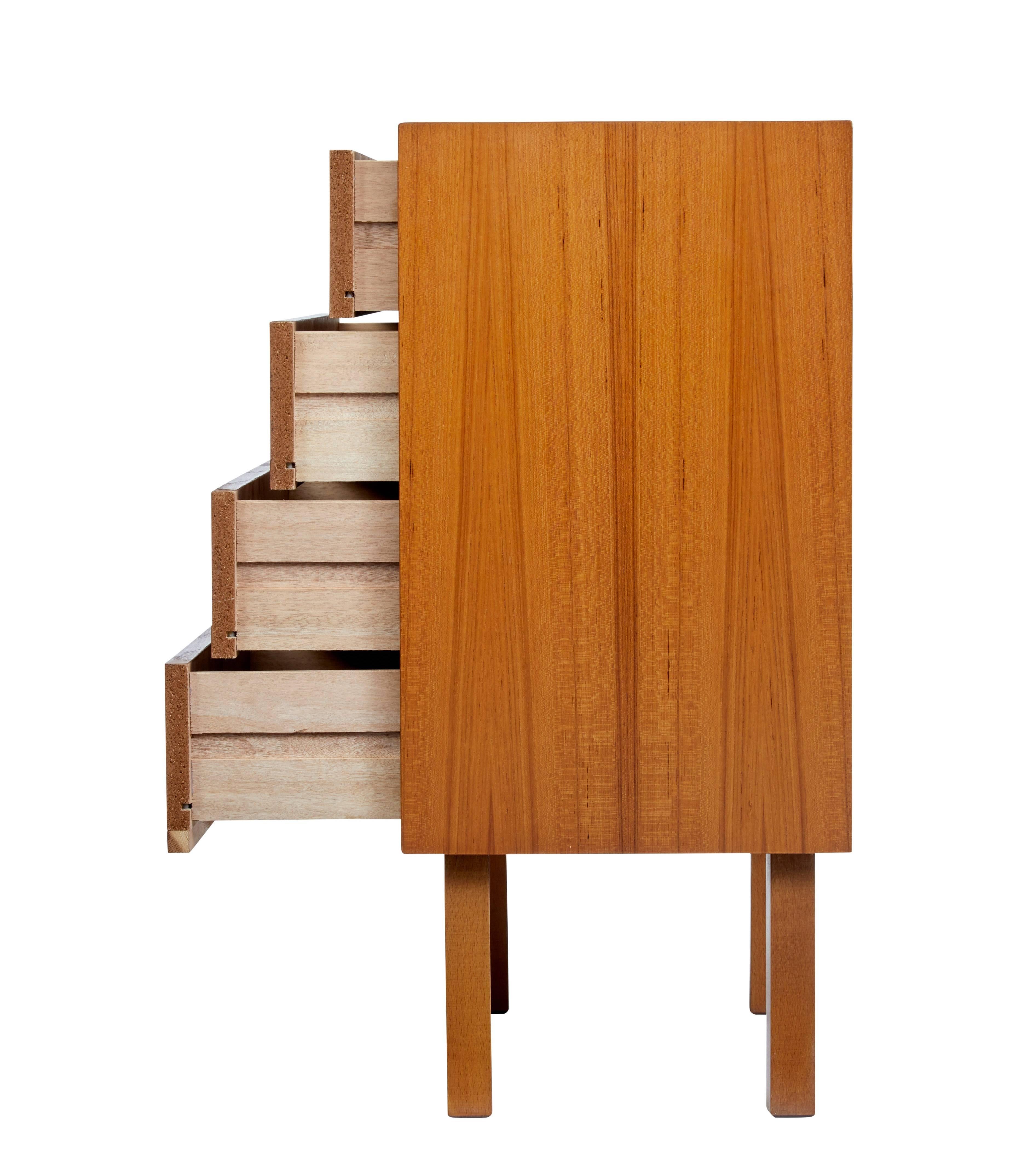 Stylish 1960's Scandinavian modern design chest of drawers.

4 drawers with turned wood handles. Standing on  straight legs.

Minor surface marks to top surface and to top drawer.