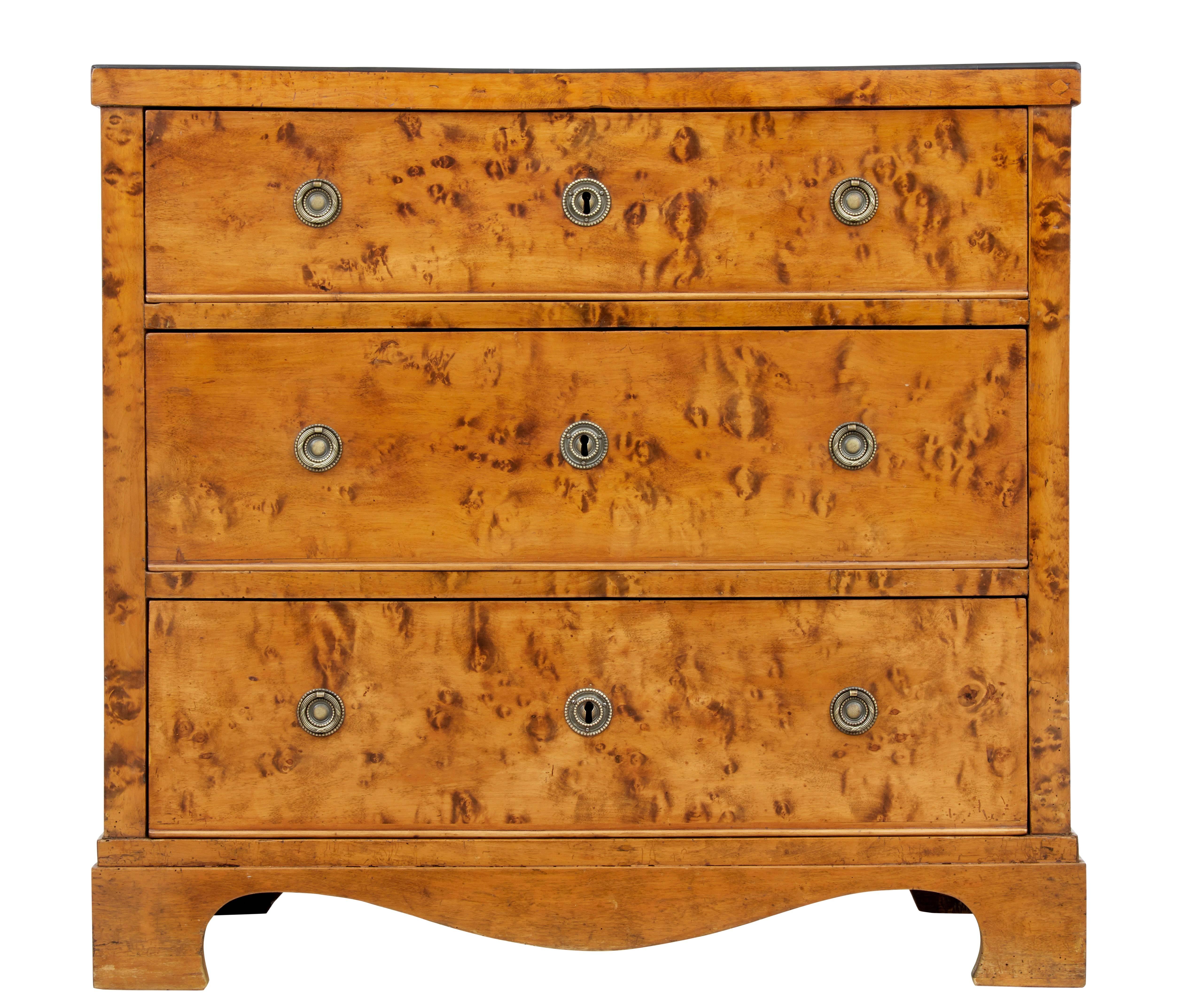 19th century Swedish birch chest of drawers circa 1870.

3 drawers with lower beaded edge, decorative brass looped handles and escutheon plates.

Beautiful burr drawer fronts and ebony edging to top surface.

Standing on bracket feet.

Obvious