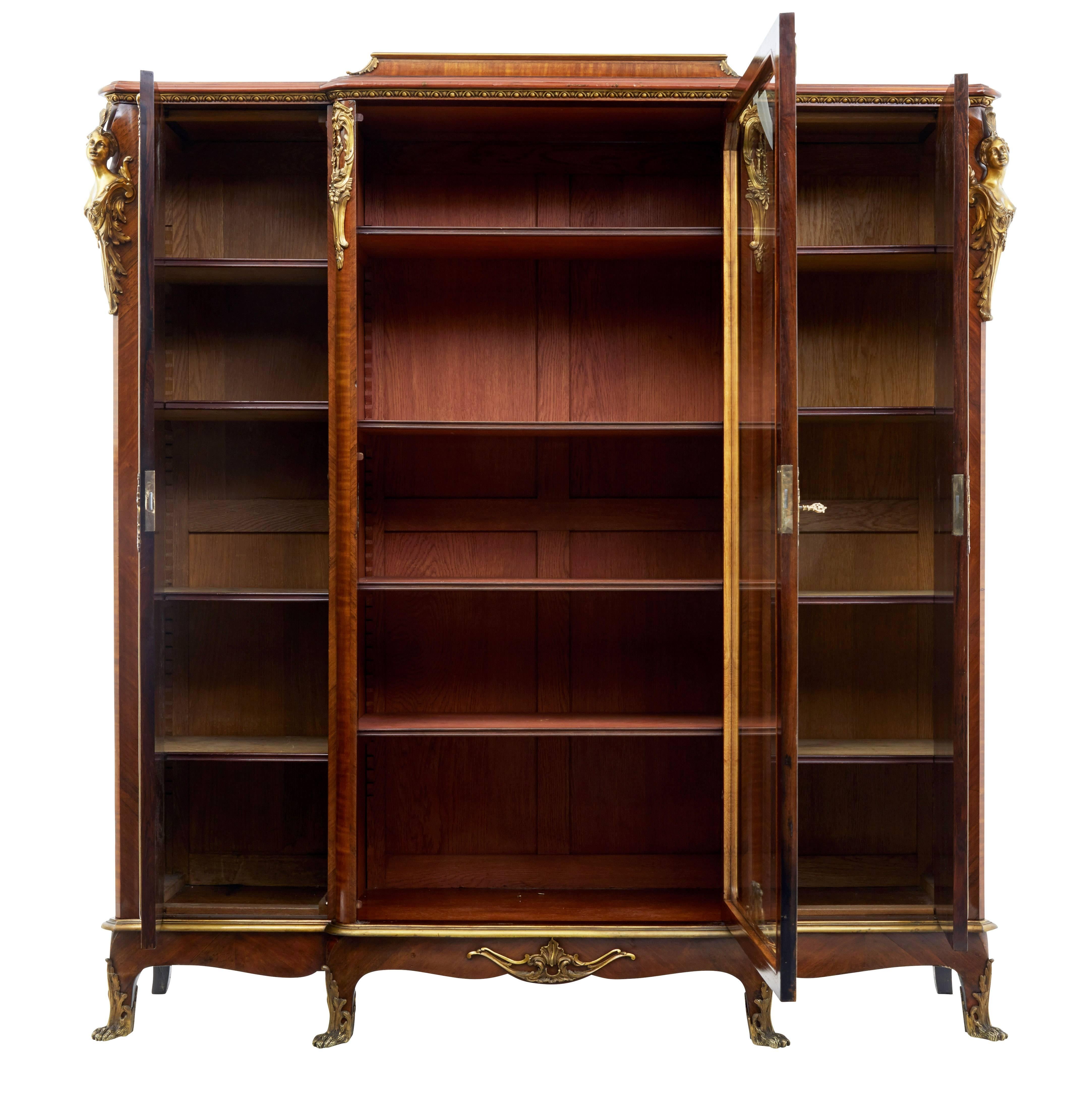 Beautiful quality French rosewood and kingwood, circa 1895.

Break fronted cabinet adorned with no expense spared ormolu mounts, main features being the shells and swags to the doors and the female busts inset into the front corners.

Front