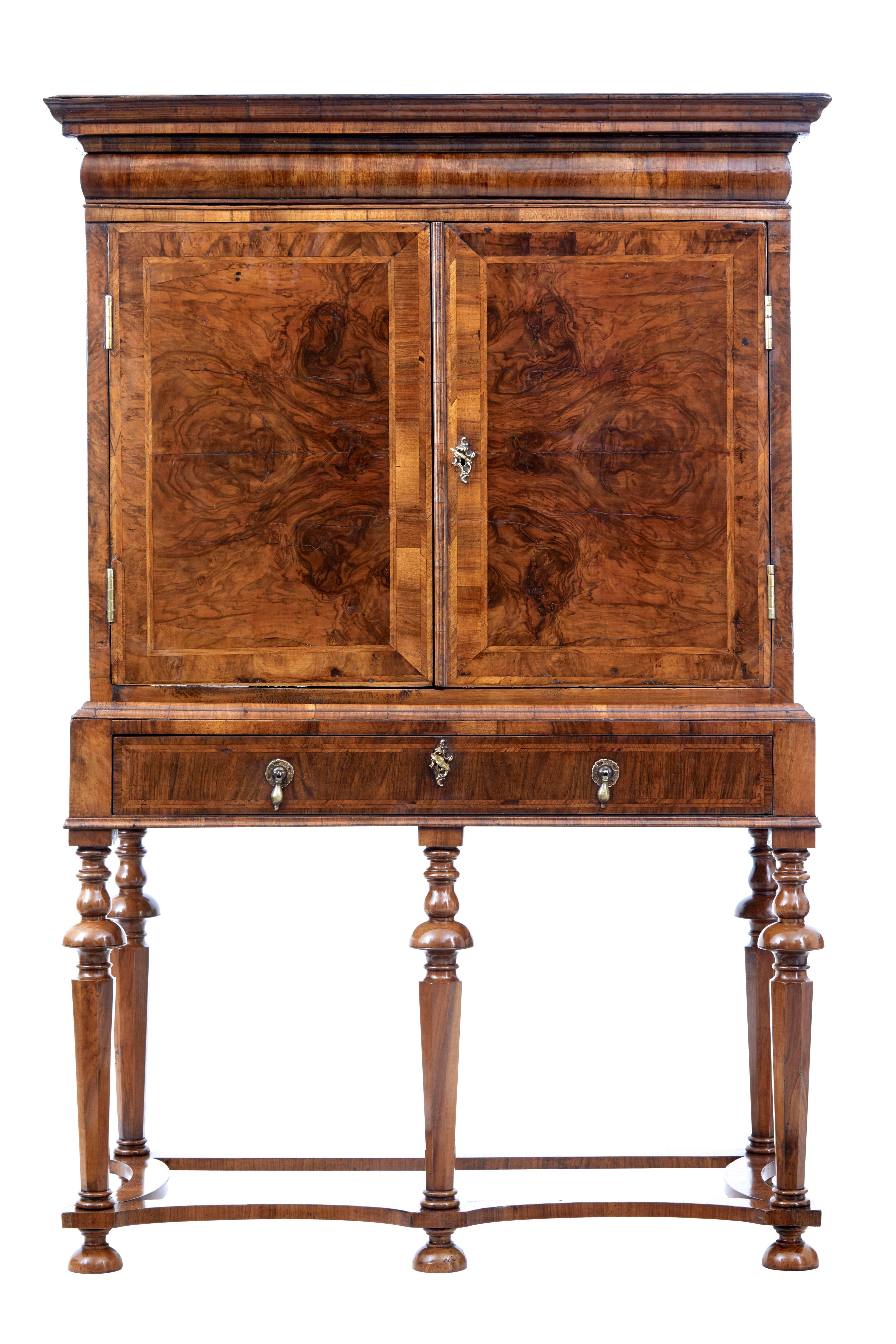 Beautiful two part walnut chest on stand, circa 1700.

Top section with pull cushion drawer directly under the top cornice, burr double doors open to reveal a fully fitted interior. Central tabernacle with 3 enclosed drawers flanked either side by