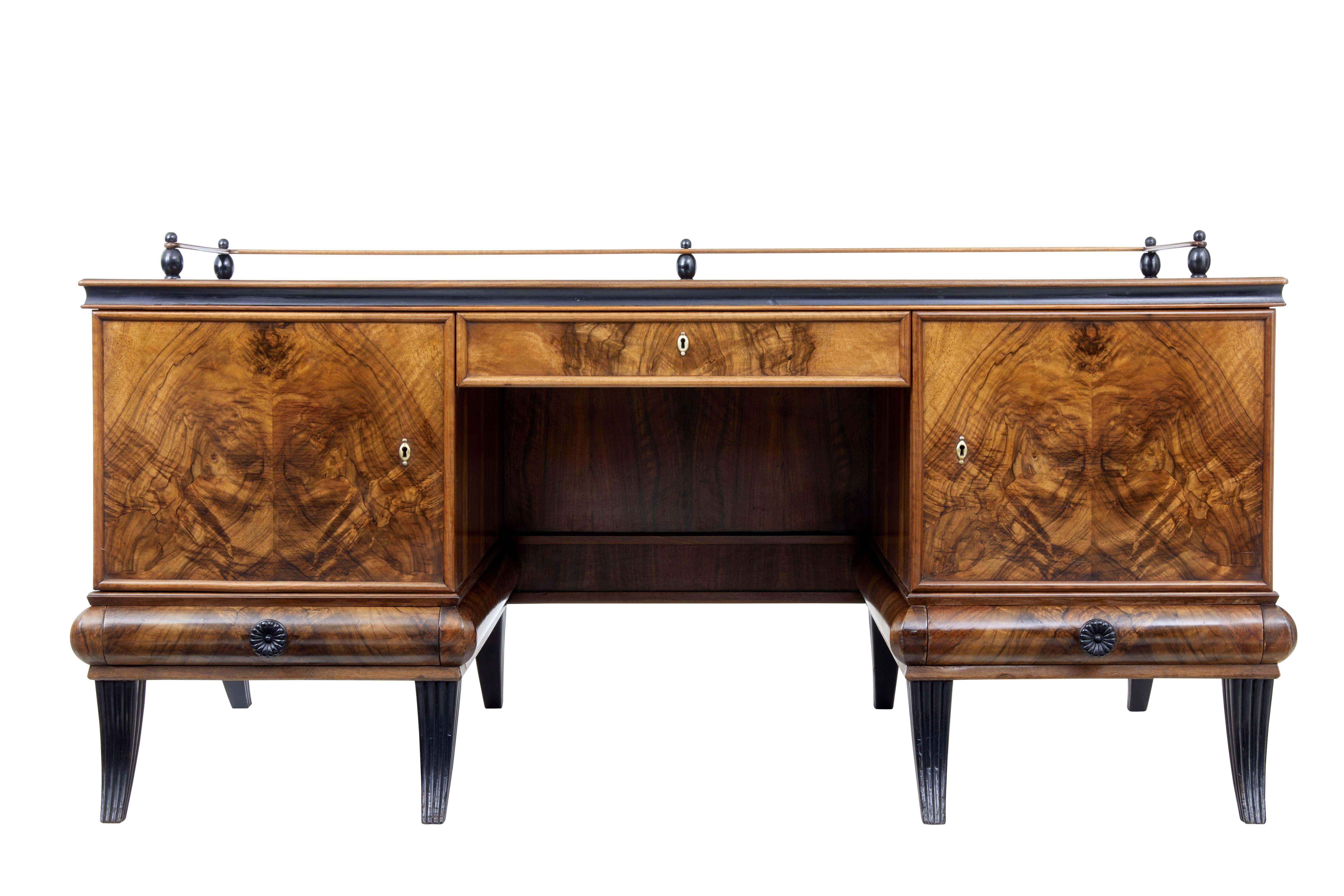 Superb quality statement desk designed for atvidaberg, circa 1930.

Large one piece desk, stunning rosewood top with decorative gallery supported by ebonized bobbins.

Single drawer above the knee hole and flanked either side by a single door