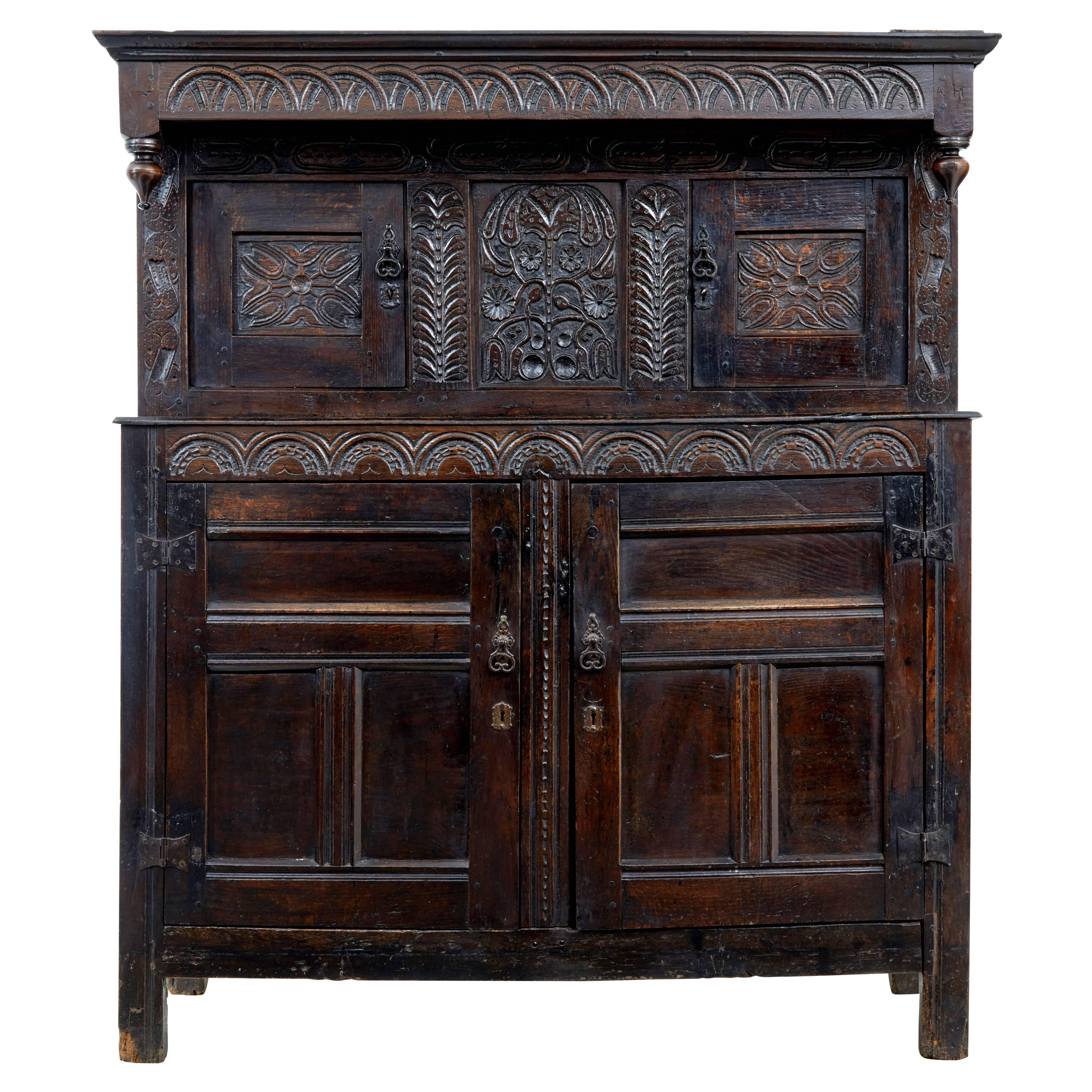 A very good quality 17th century carved oak court cupboard, circa 1650.

Beautiful patination to this two part court cupboard. Very good quality carving with the main feature being the central panel depicting the tree of life. The top corner bares