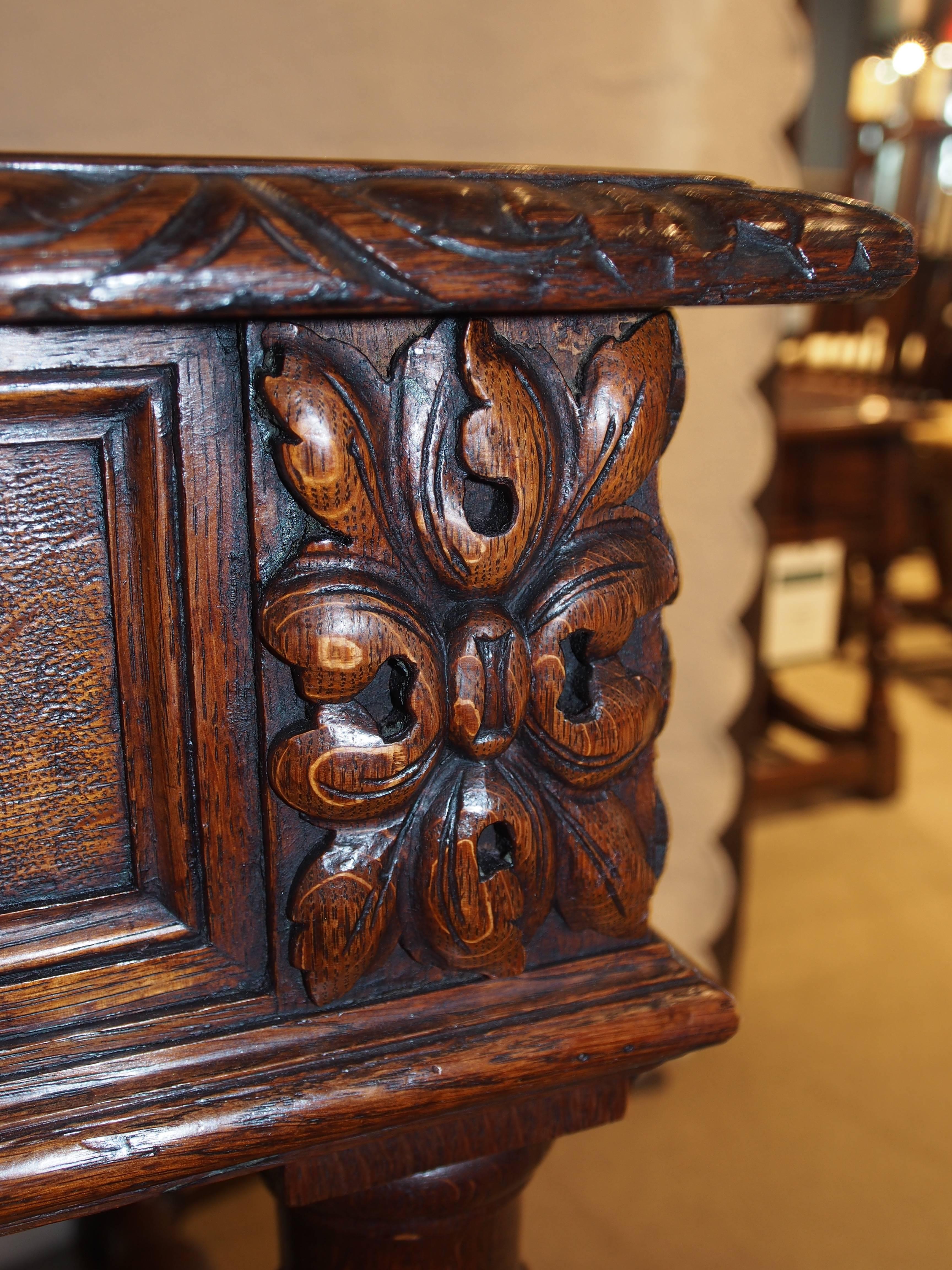 Desk in oak, circa 1890. Ornate side and corner carvings and barley twist legs and stretcher.