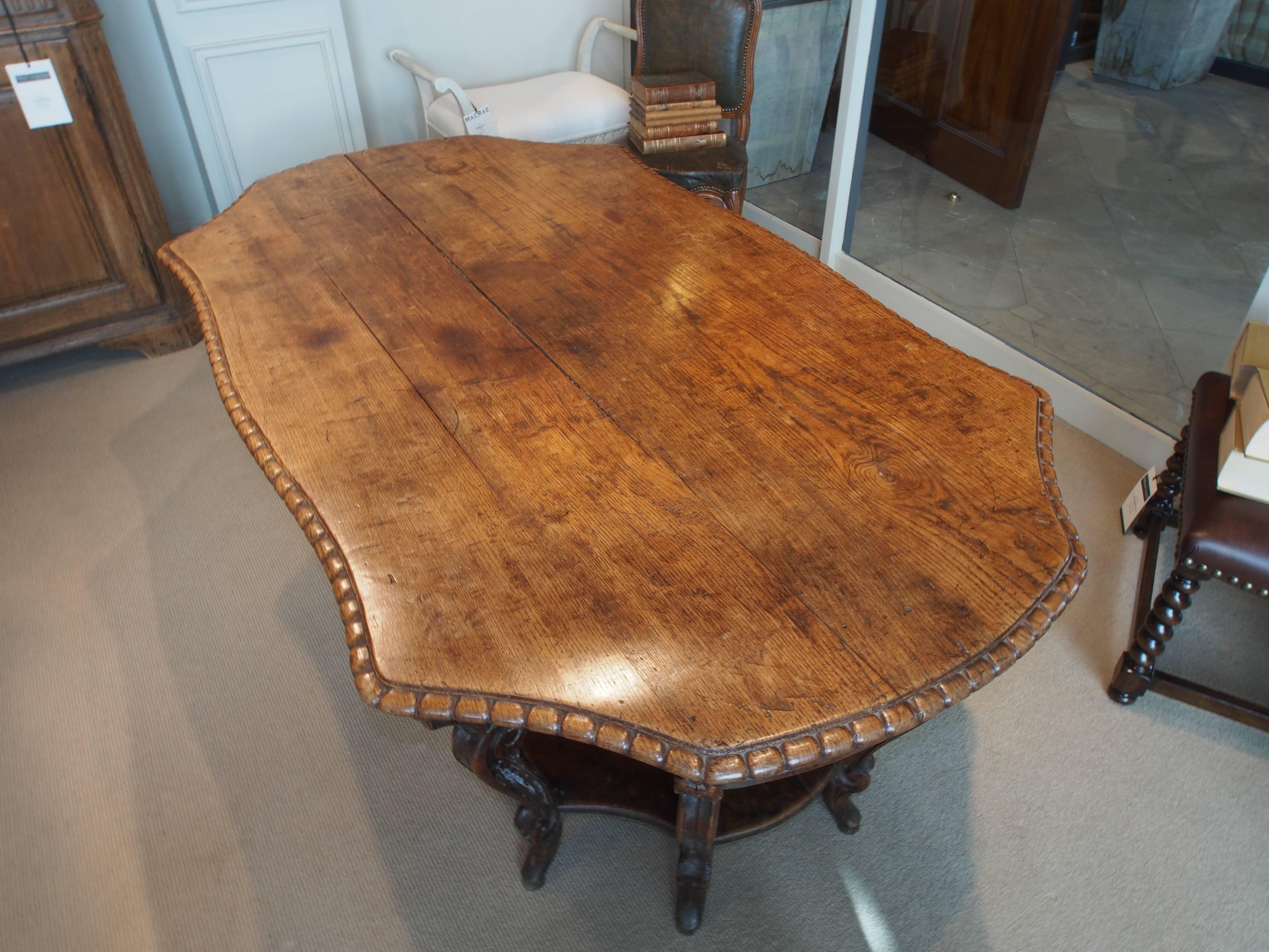 Walnut Italian carved table with eight legs and ornate carvings through out.  Light marks and stains, please see photos.