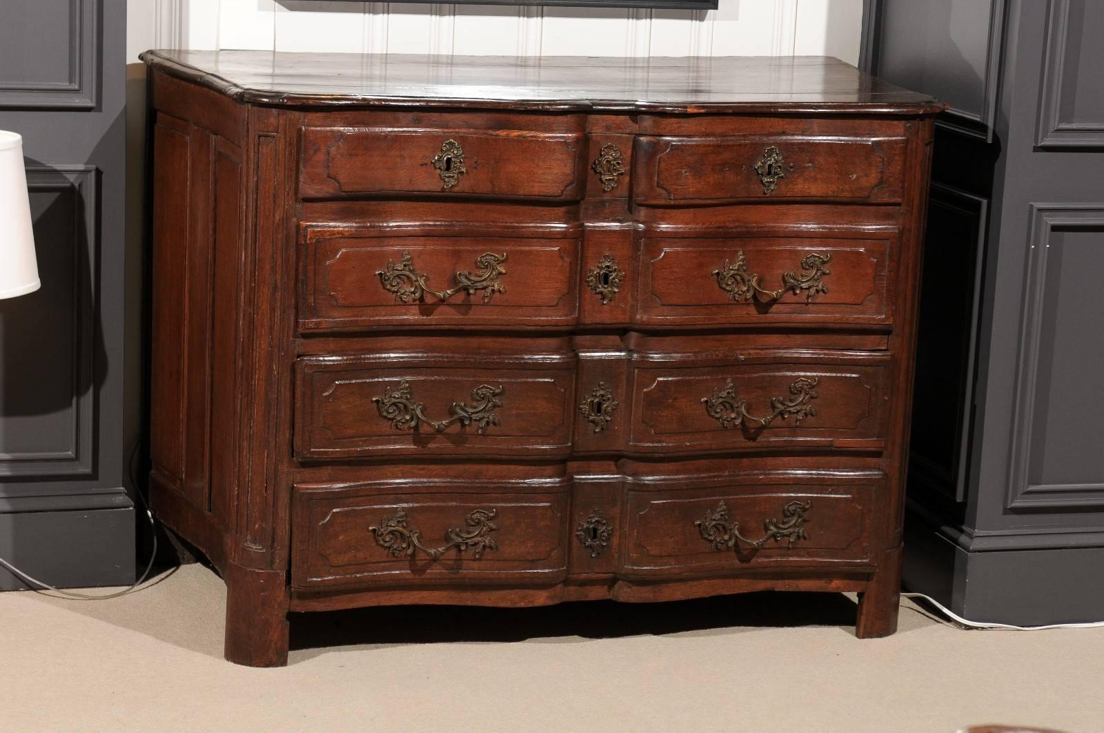 Four-drawer chest from France in walnut. Ornate, original hardware on all drawers.