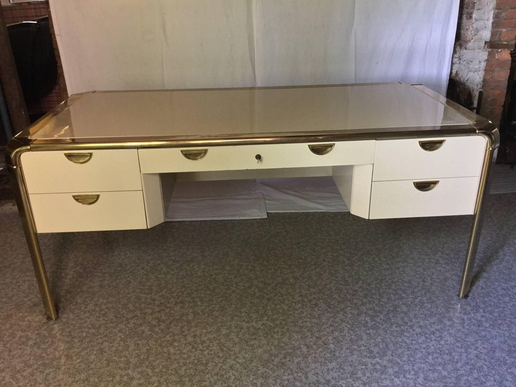This desk is straight out of a retired executives office at the Boston Institute of Art.
It's top craftsmanship here. The size is grand, the condition is excellent. The brass shines with light patina here and there. The paint color is an antique