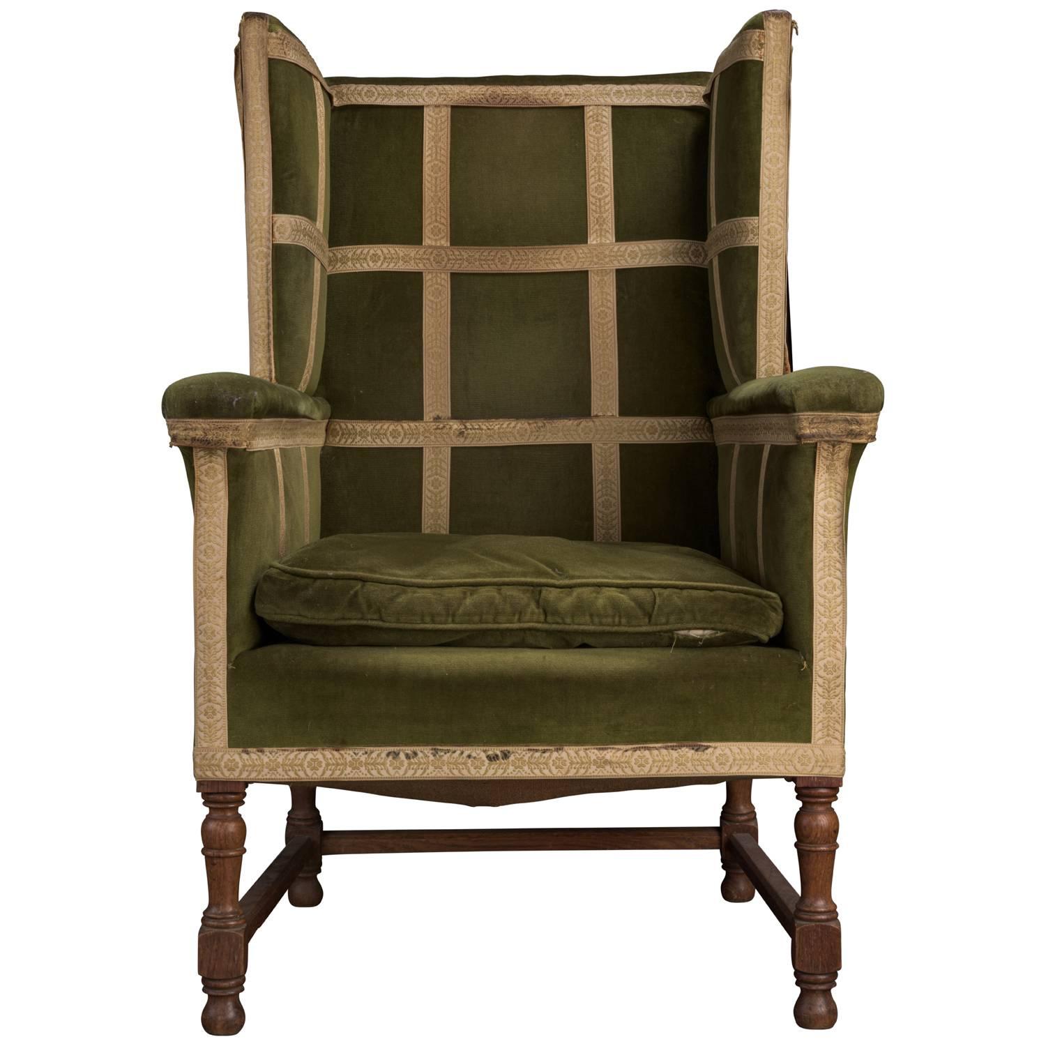 Green velvet upholstery with turned oak legs.