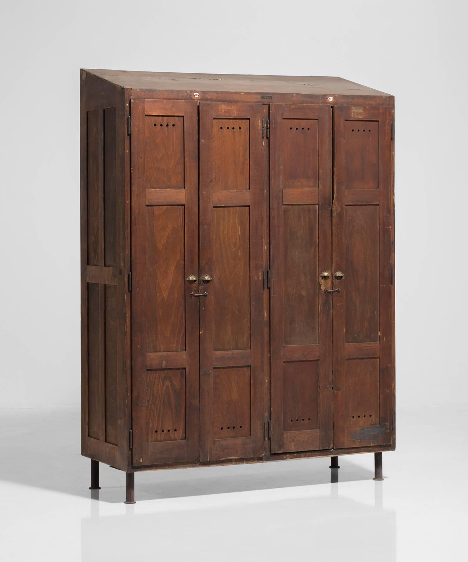 Ornate solid wood locker unit with brass hardware.