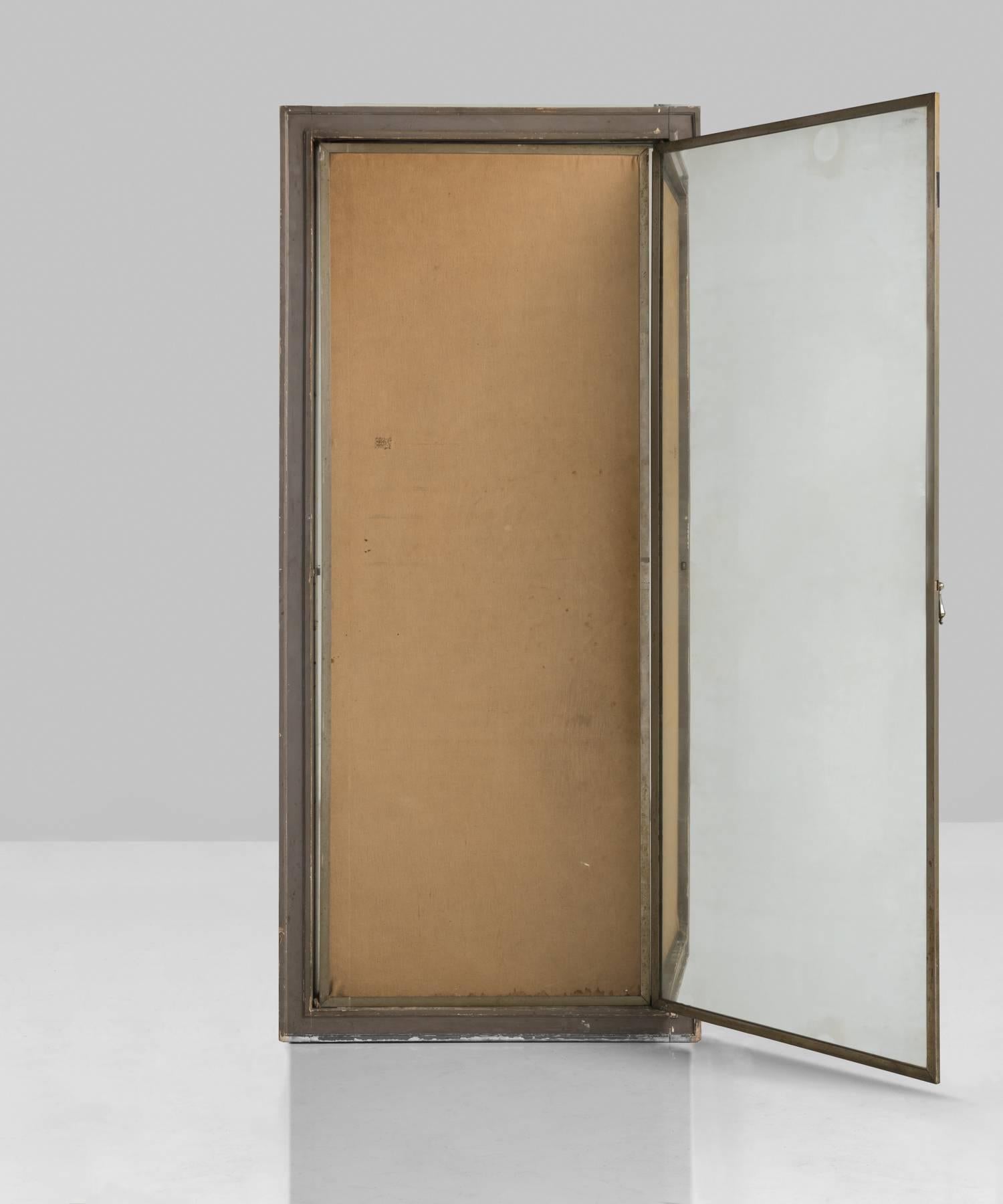 Original plate glass mirrors set within a collapsing brass framework, inset within a painted grey wood frame; natural linen backing to mirrors, France, circa 1920.