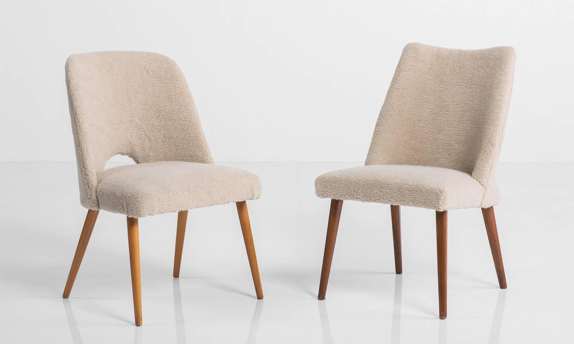 Unique set of chairs with soft faux wool upholstery on tapered teak legs; two end chairs have small cut-out in the lower back as an additional design element, France, circa 1960.