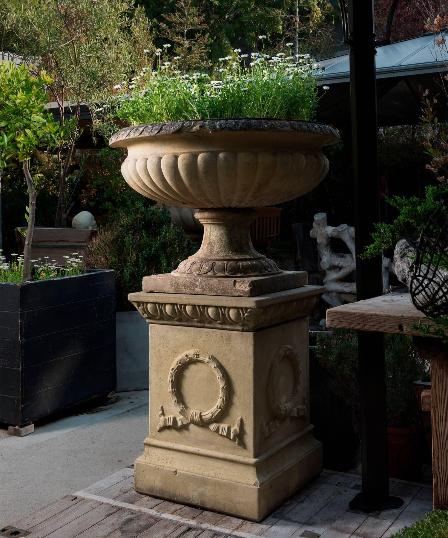 Cast stone composite urn with filigree details, wonderful to plant with Irish moss, England, circa 1970.