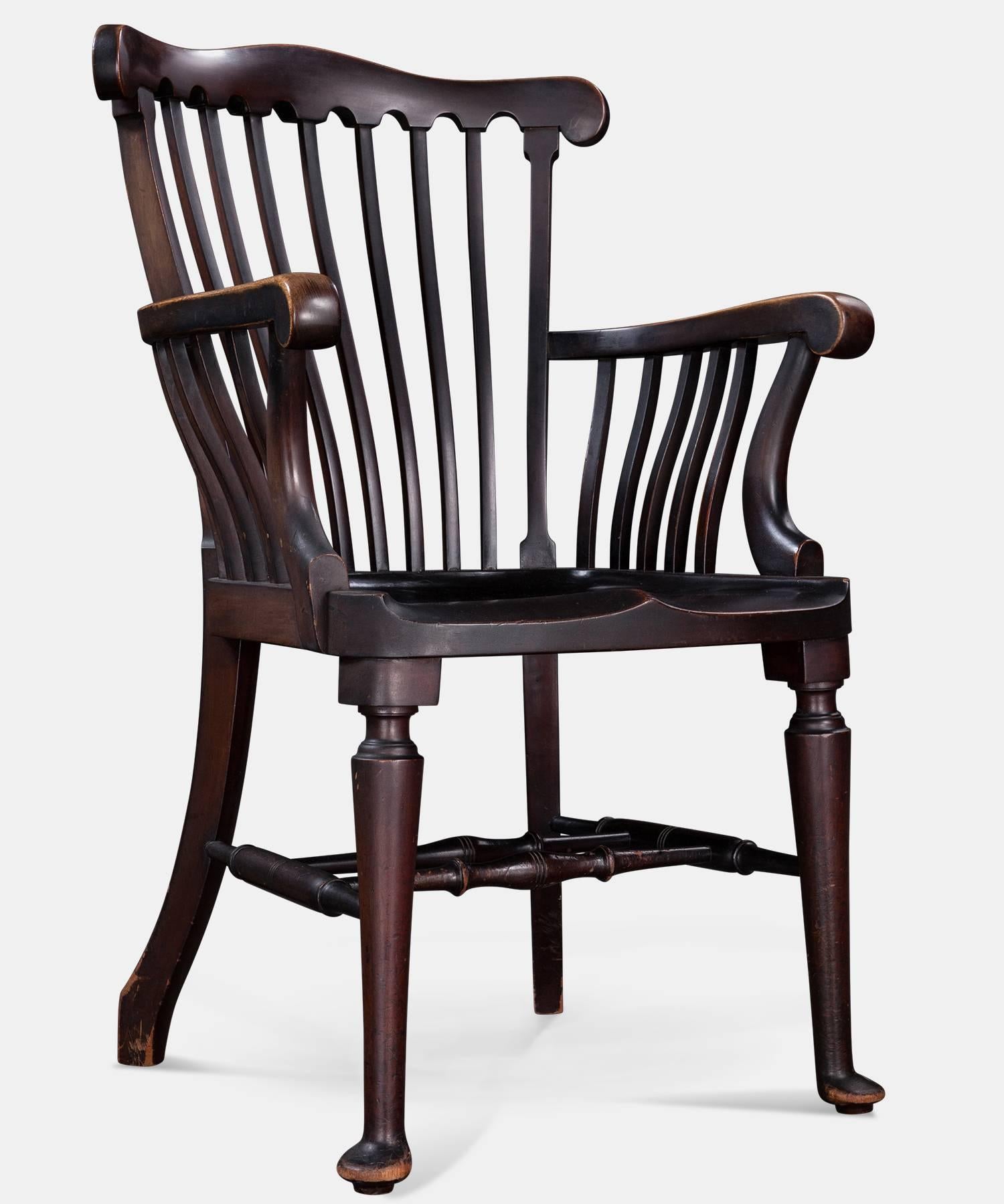 Walnut elbow chairs, England, circa 1900.

Closely matched armchairs with slatted back and saddle seats. 