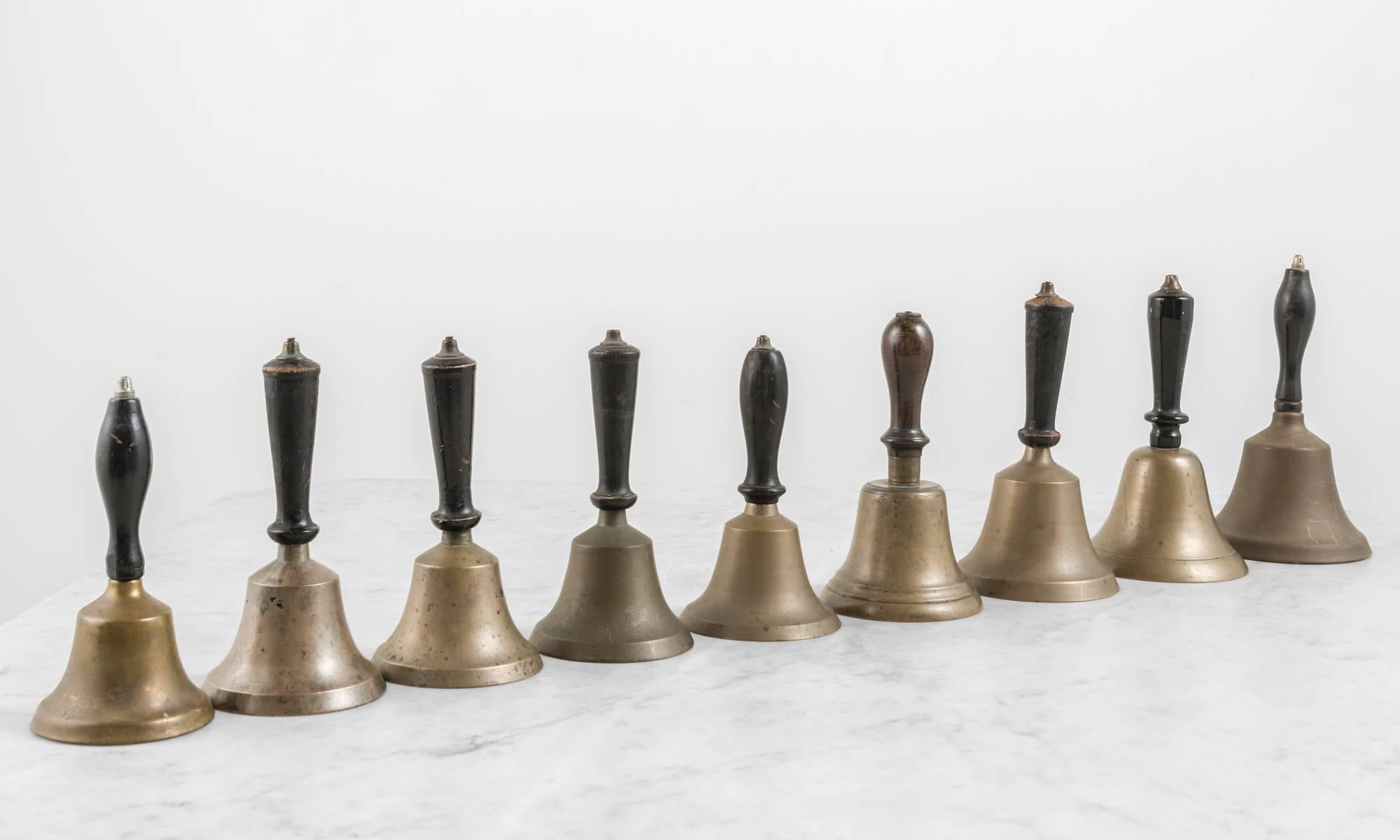 Assortment of hand bells with ebonised and turned handles.

Made in America, circa 1900-1940.