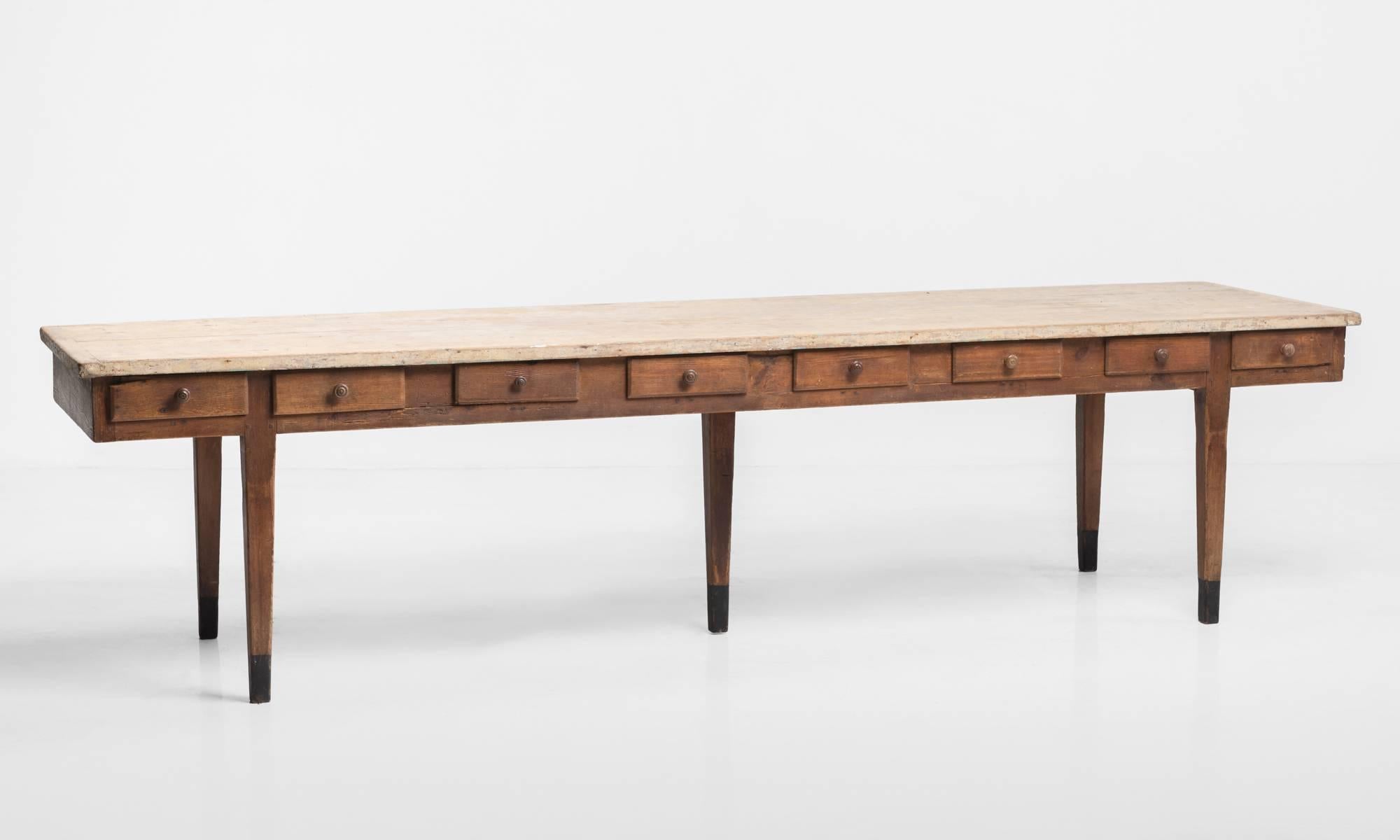 Unique form with scrubbed top, pull-out drawers and five legs.