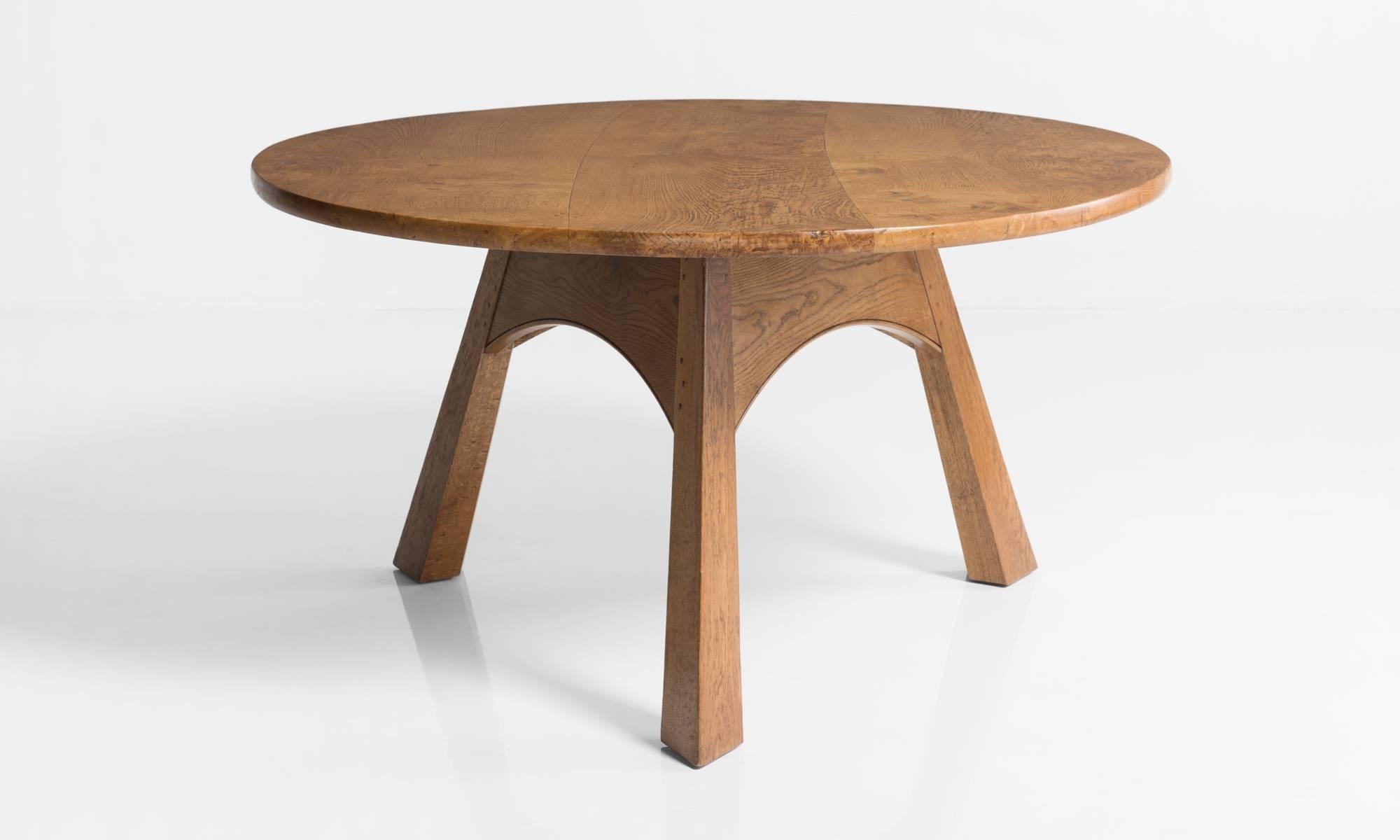 Round Oak Dining Table, made in England circa 1930.

Generous sized, elegant dining table in the Cotswold style with a triform base.