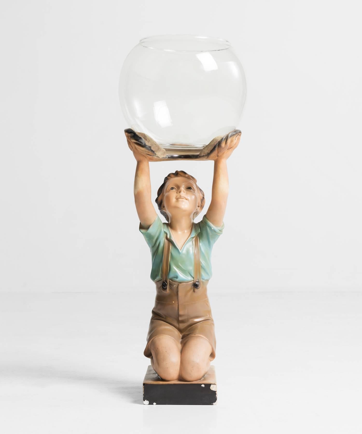 Goldfish Bowl and Statue, made in Italy circa 1950.

A glass bowl supported by a hand painted plaster statue of a young boy on pedestal.