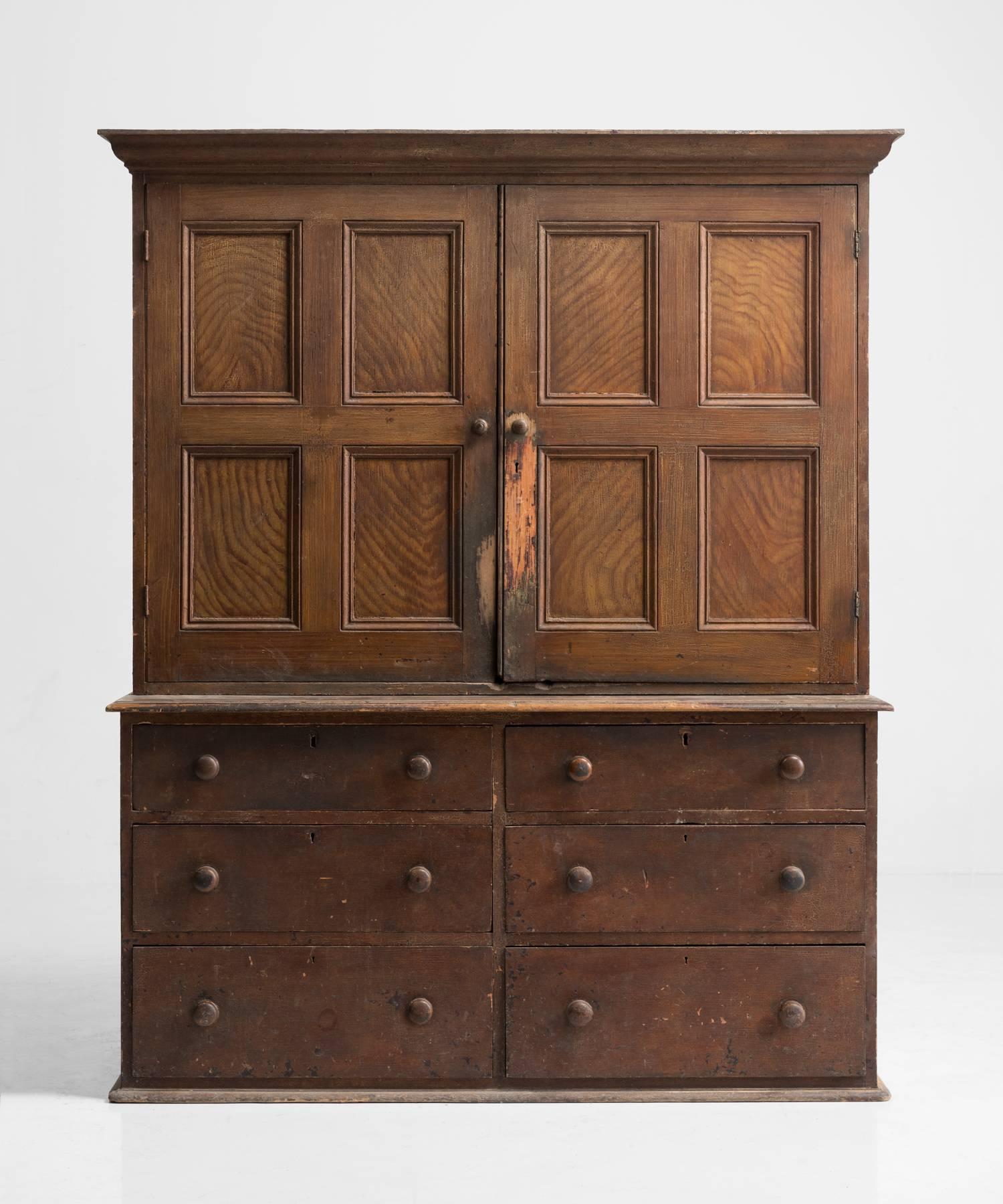 Pine housekeepers cupboard, made in England, circa 1850.

Pull out drawers on base with paneled doors and storage.