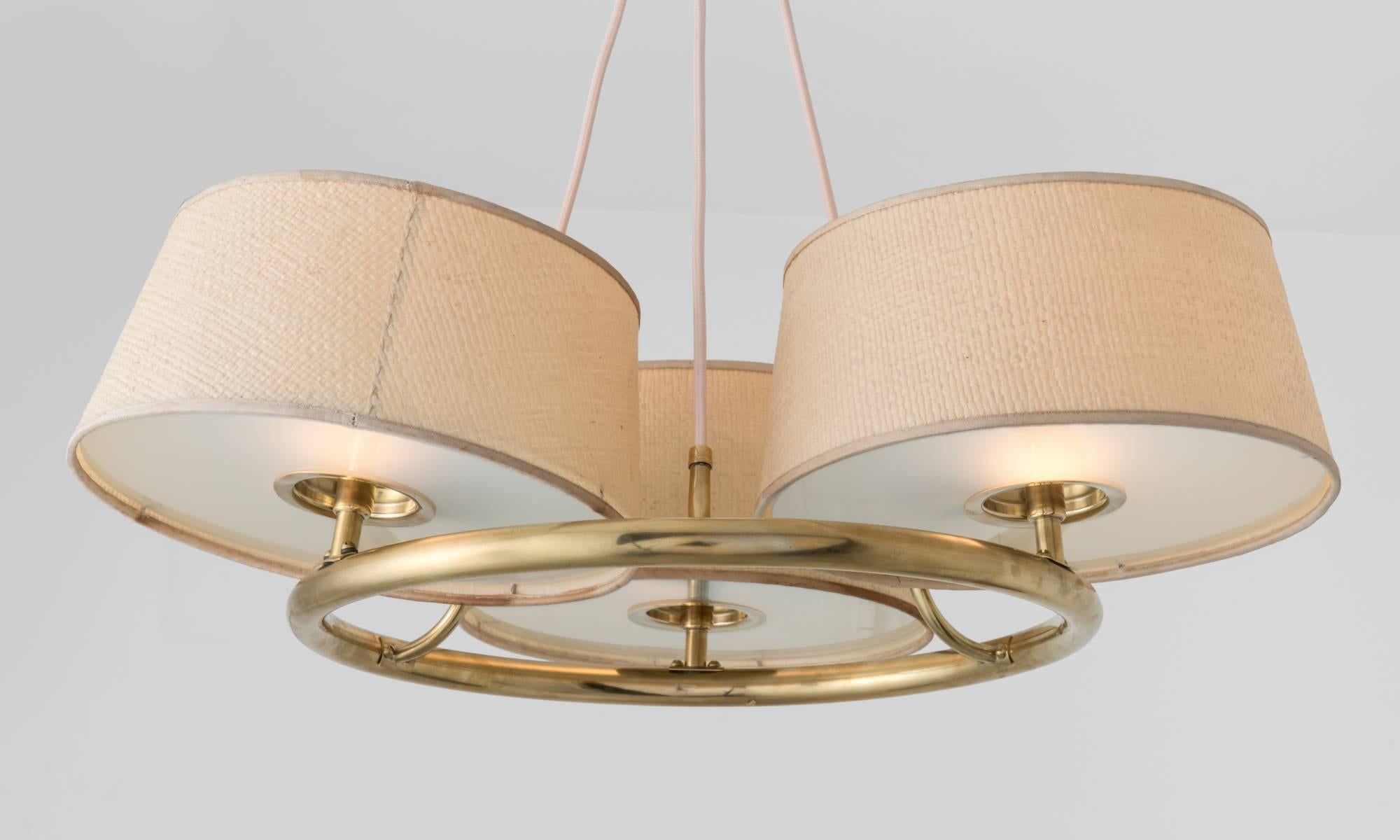 Paavo Tynell Chandelier, circa 1950

Elegant circular form with polished brass hardware, frosted glass and linen shades. 

8