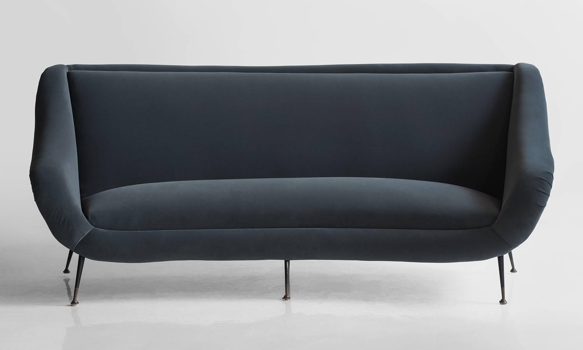 Curved form, newly reupholstered in Maharam fabric.