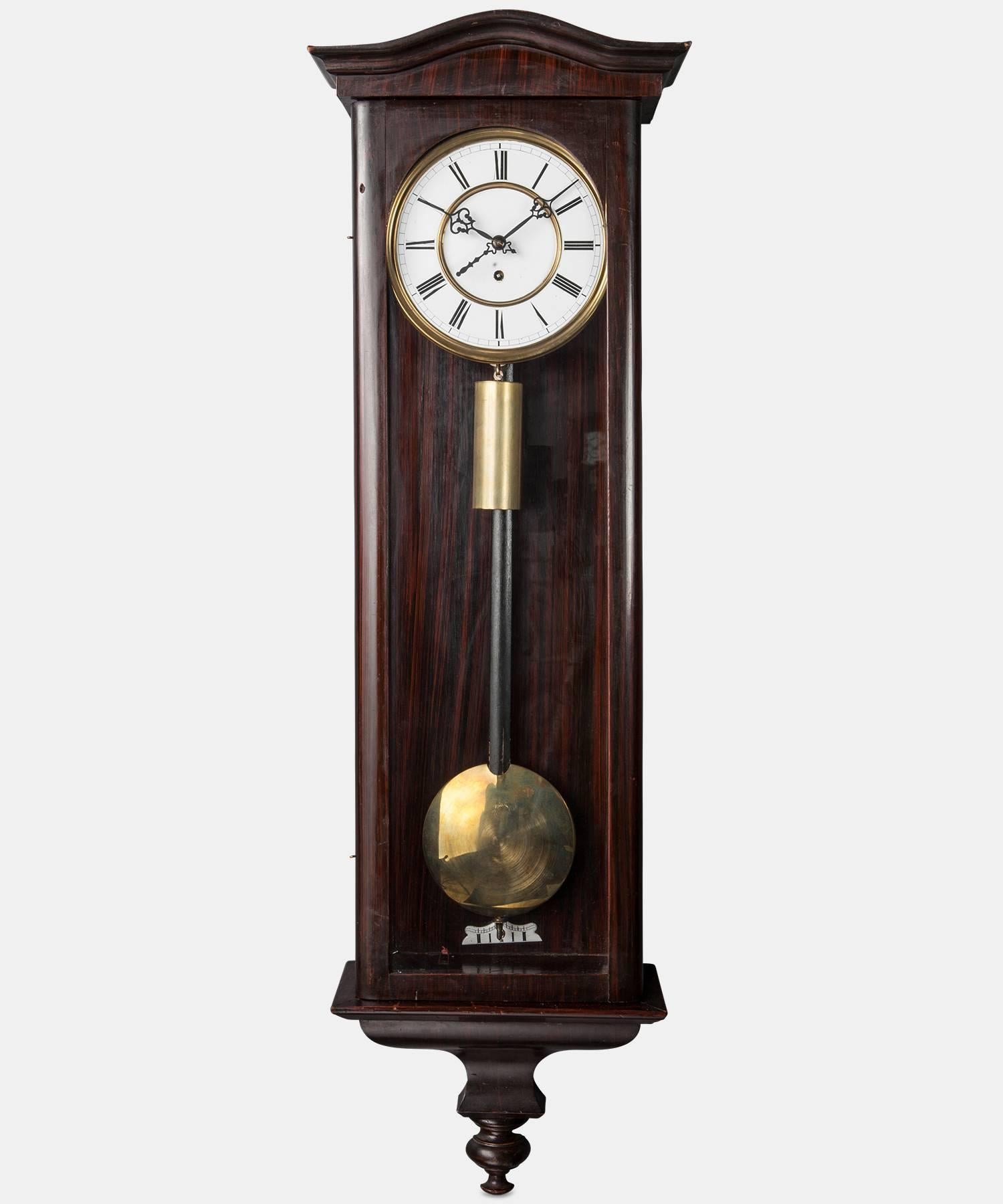 Clock with walnut frame, porcelain face and solid brass weight.

Made in America circa 1920.