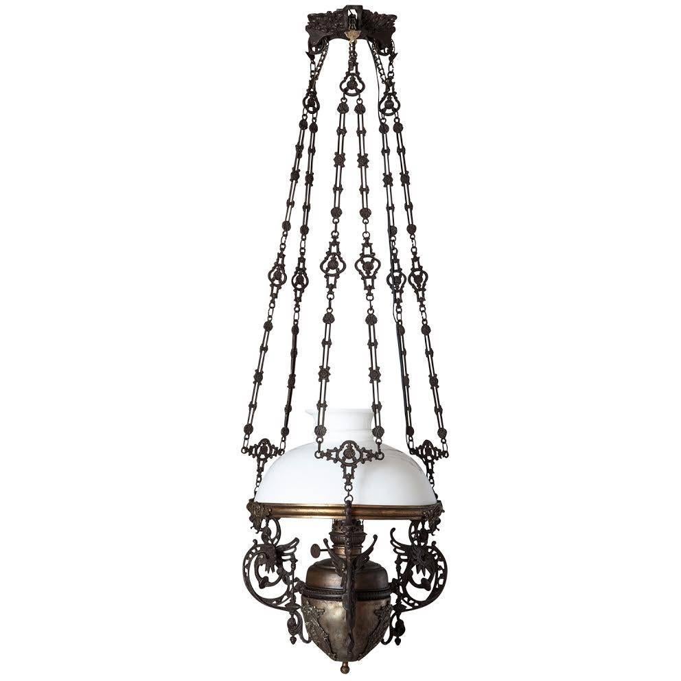 Ornate Bronze Milk Glass Pendant, circa 1880

Bronze oil lamp converted to electric, with ornate suspension and original milk glass shade.

Overall height adjustable.