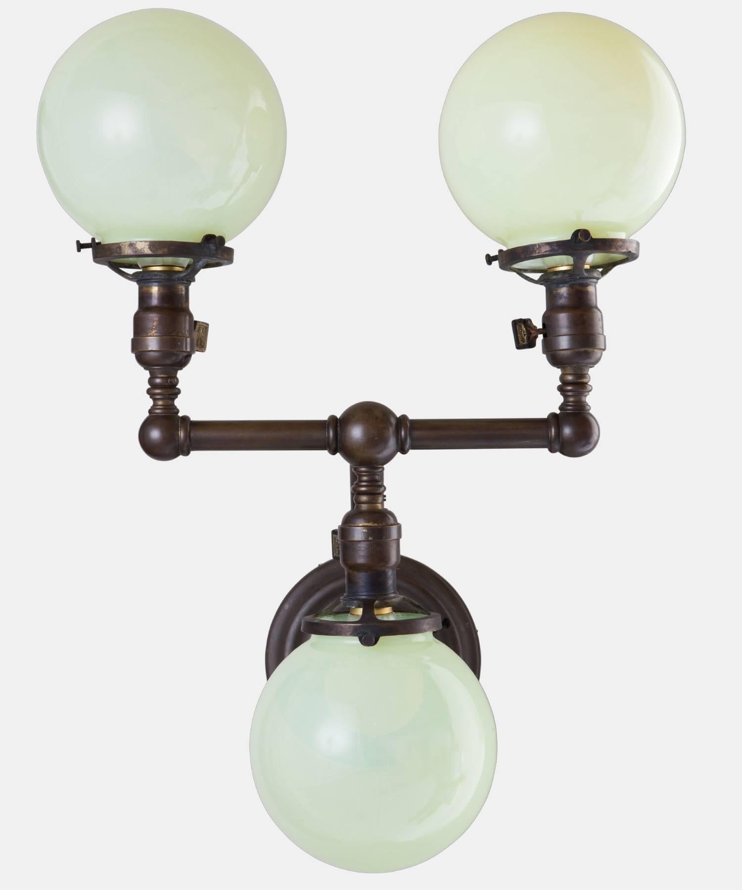 American Pair of Brass and Vaseline Glass Three Globe Sconces, circa 1920