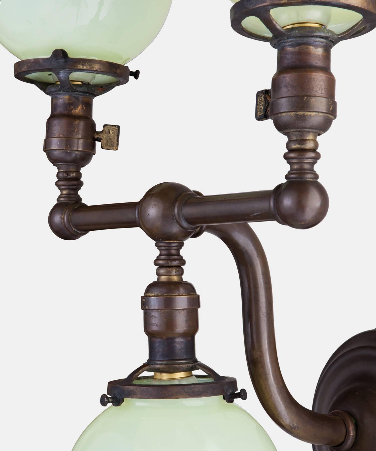Pair of Brass and Vaseline Glass Three Globe Sconces, circa 1920 In Good Condition In Culver City, CA