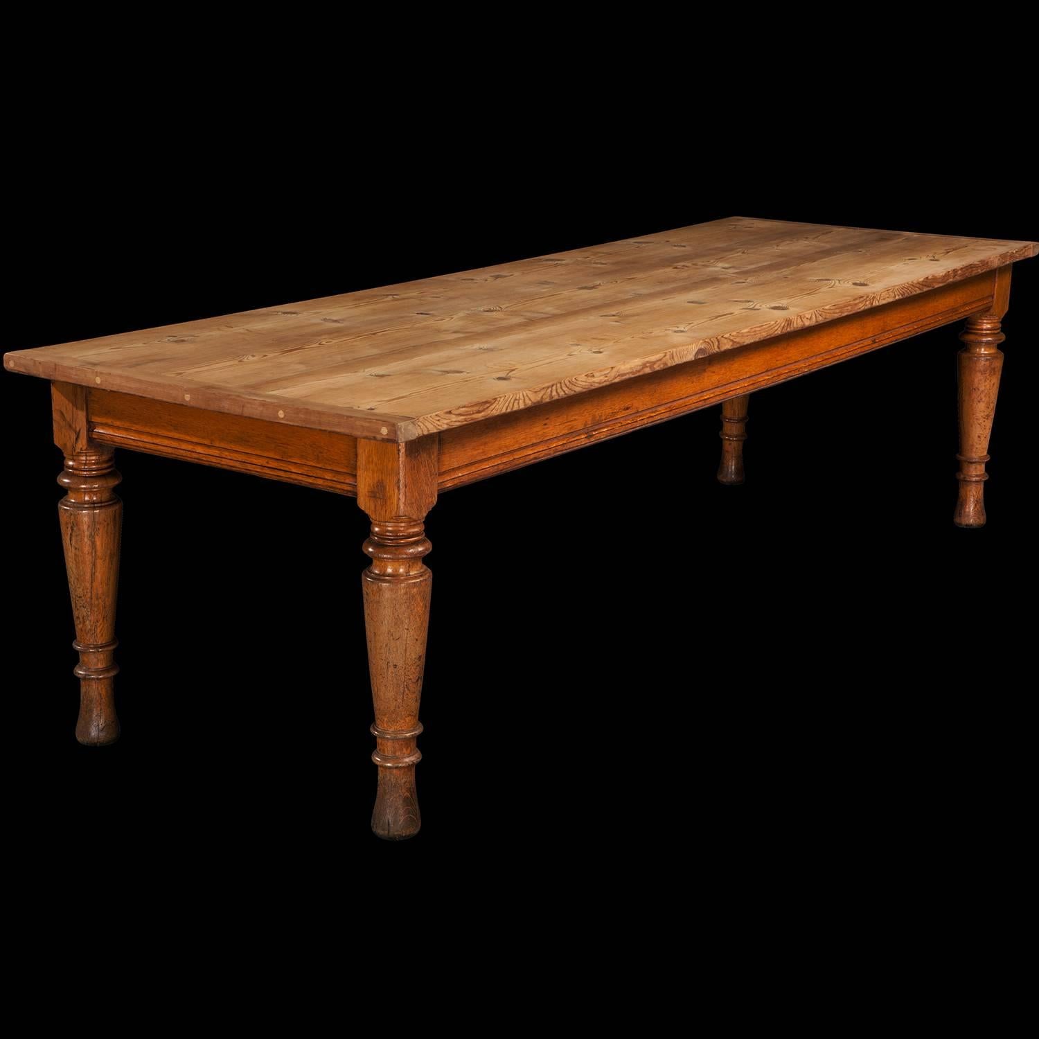 Scrubbed pine top with decorative square lozenges set into the top in the centre. Solid oak base with turned legs.