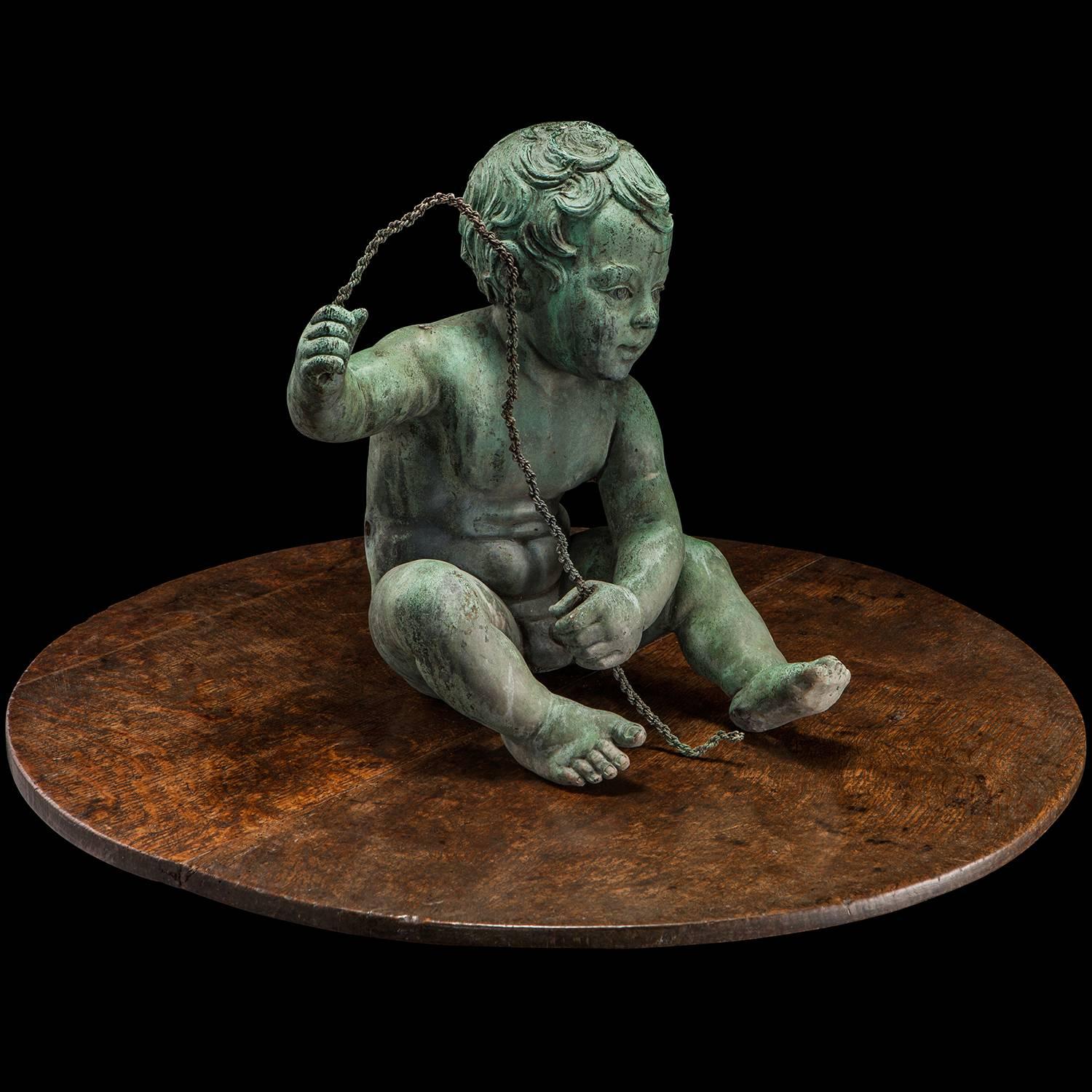 Wonderful cast bronze statue of a young boy, holding the remnants of a fishing line.