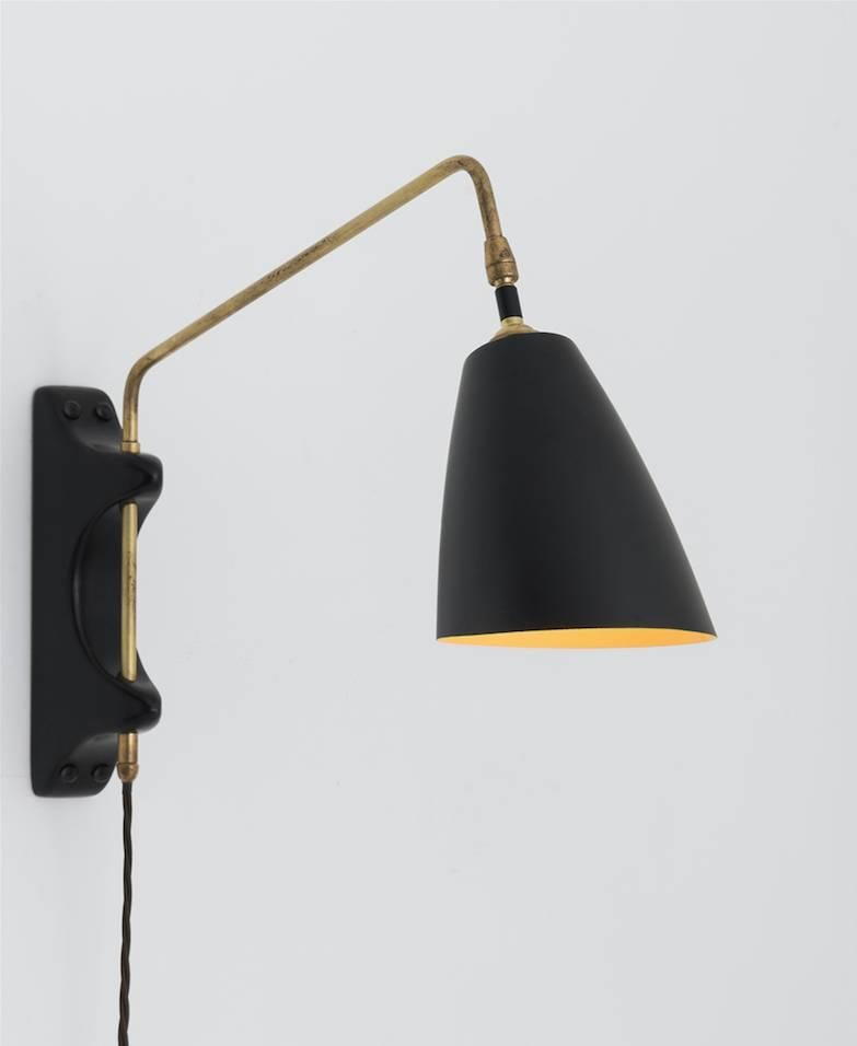 With ebonised wood backplate, brass hardware, and black metal shade. Interior can be painted saffron yellow. 

Made in England

Please specify amount of cord, on / off switch location on cord, and hardwired or plug in.

*Please Note: This fixture is