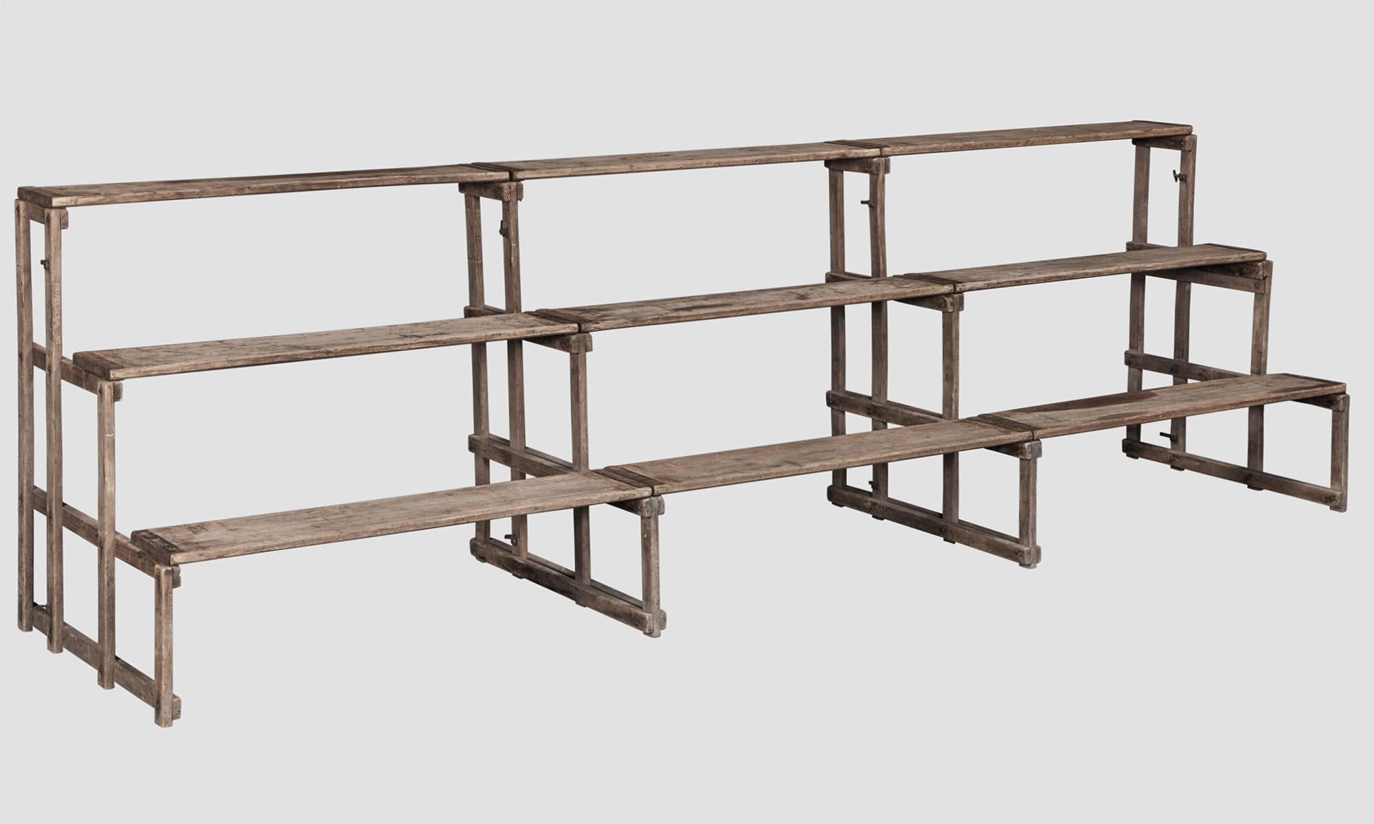Series of five connecting pinewood bleachers with iron supports. Three pictured. Sold as a set.
