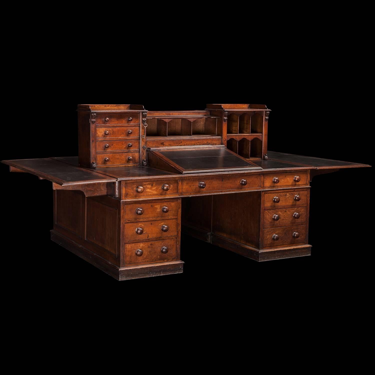 Incredible oak partners desk, with black leather inserts, and folding leaves. Wonderfully intricate and functional desk, custom made for a railway office just outside Gillows.