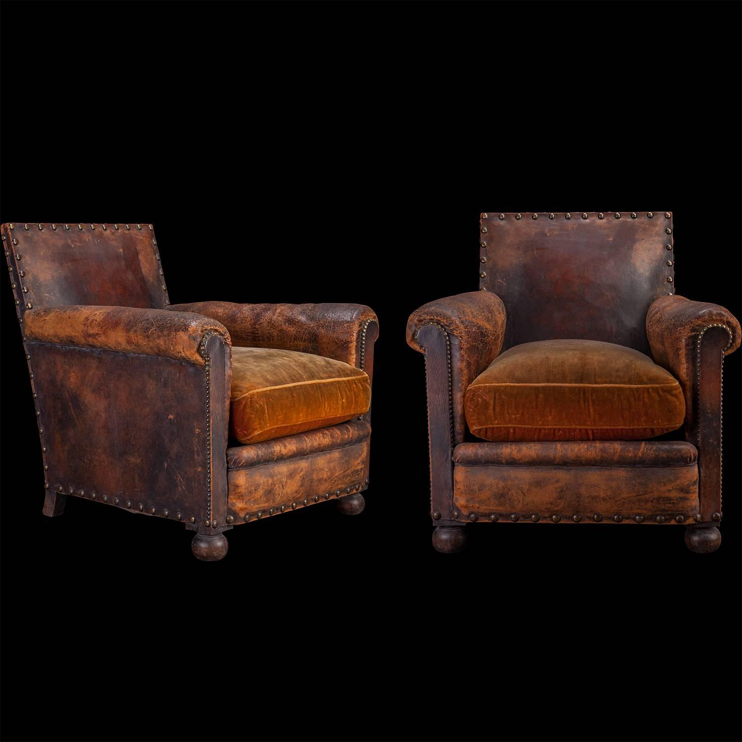 Original leather and velvet upholstery armchairs.