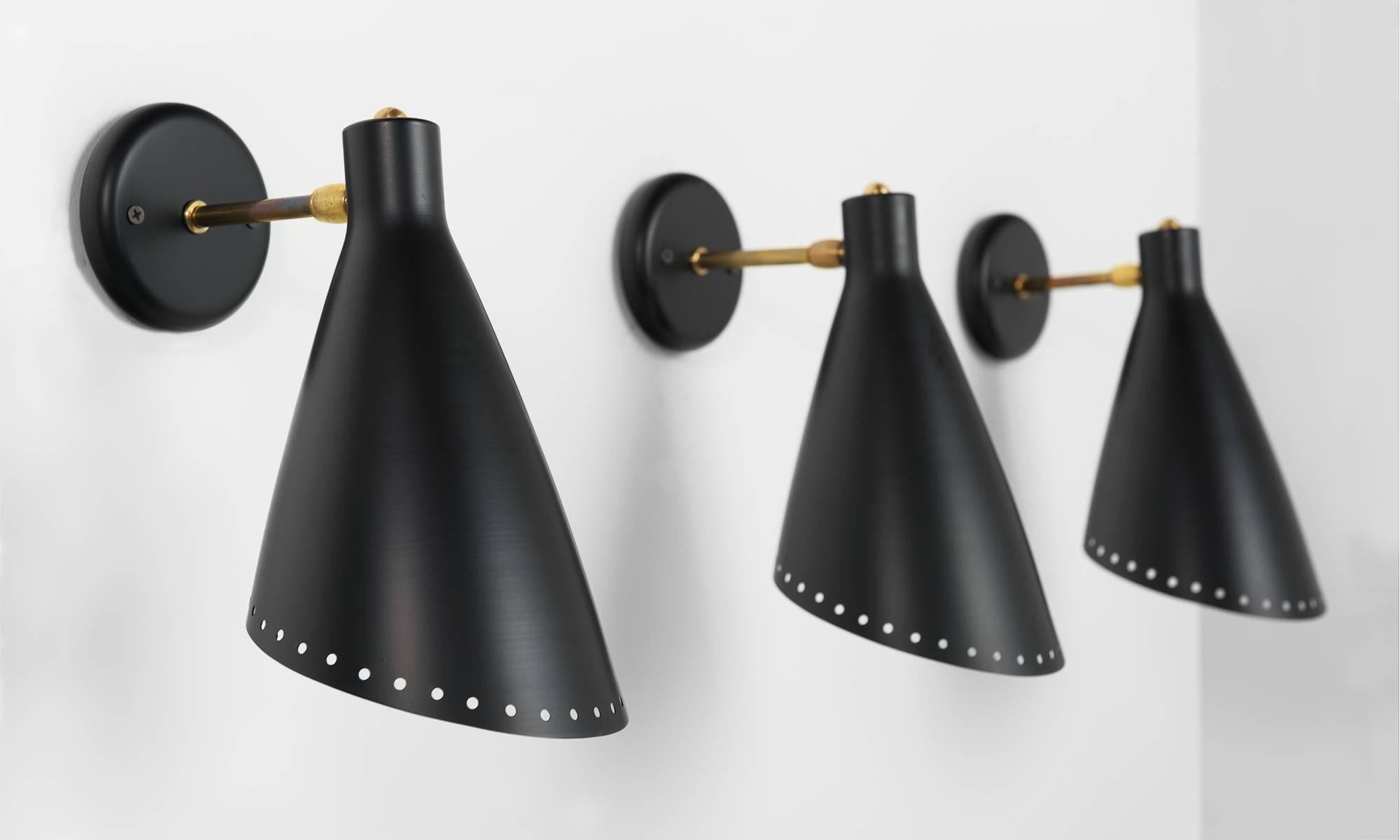 Adjustable Brass and Black Metal Sconce, circa 1950

Cone shade features a perforated motif and is adjustable at attached brass arm.