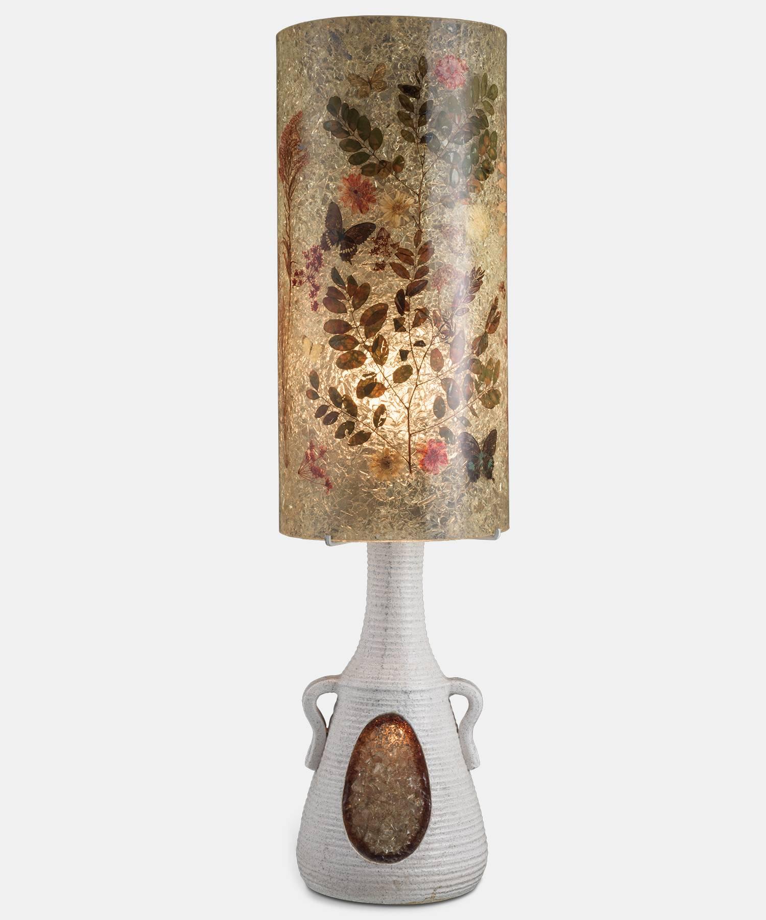 Accolay Ceramic and Resin Table Lamp, circa 1970. 

Large lamp of Accolay workshops composed of a ceramic and resin base, and a resin lampshade decorated with plants and butterflies. There are two bulbs, one in the shade and the other one in the