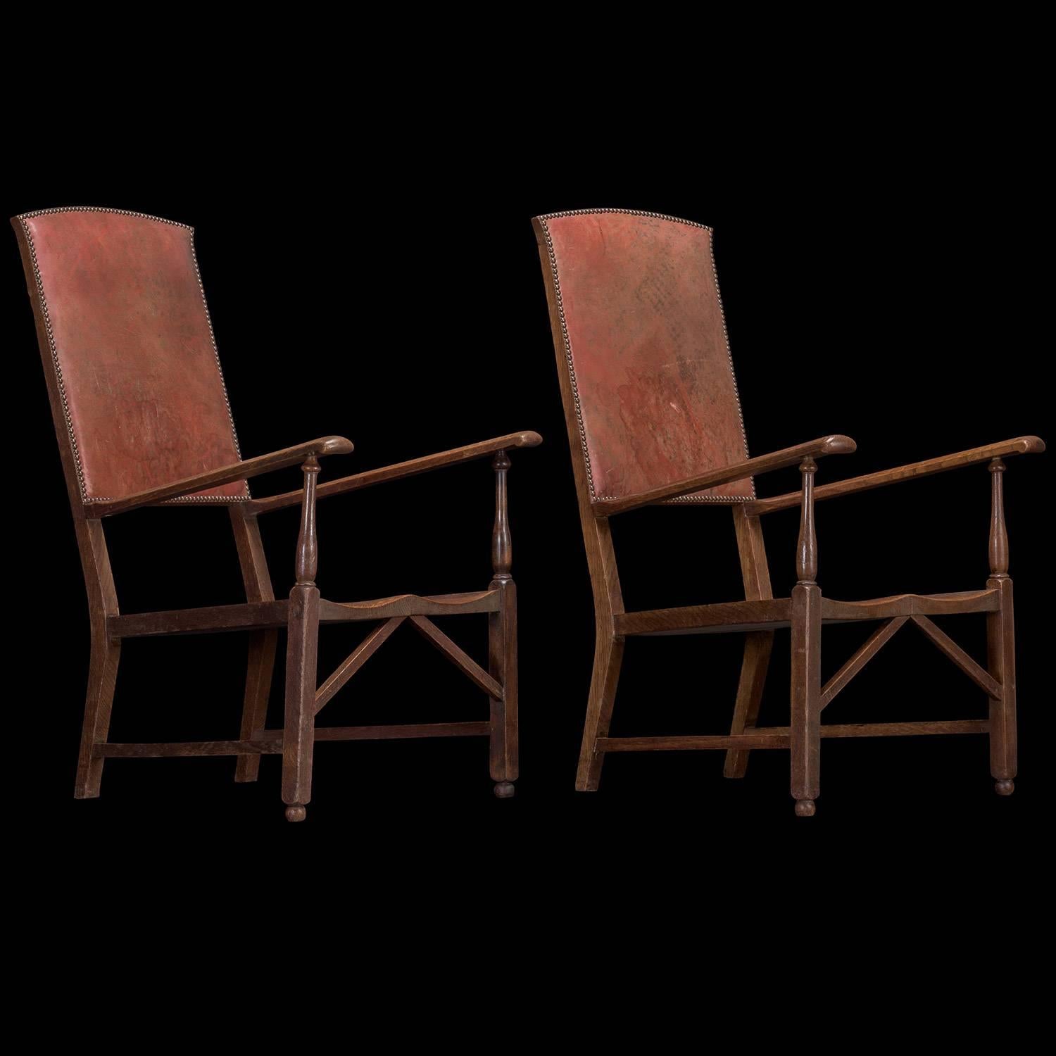 Pair of Oak and Leather Armchairs, from England circa 1900.

Edwardian armchairs featuring solid oak construction with unique architectural form. Each chair has a moulded oak seat, with original leather upholstery on the back fitted with brass