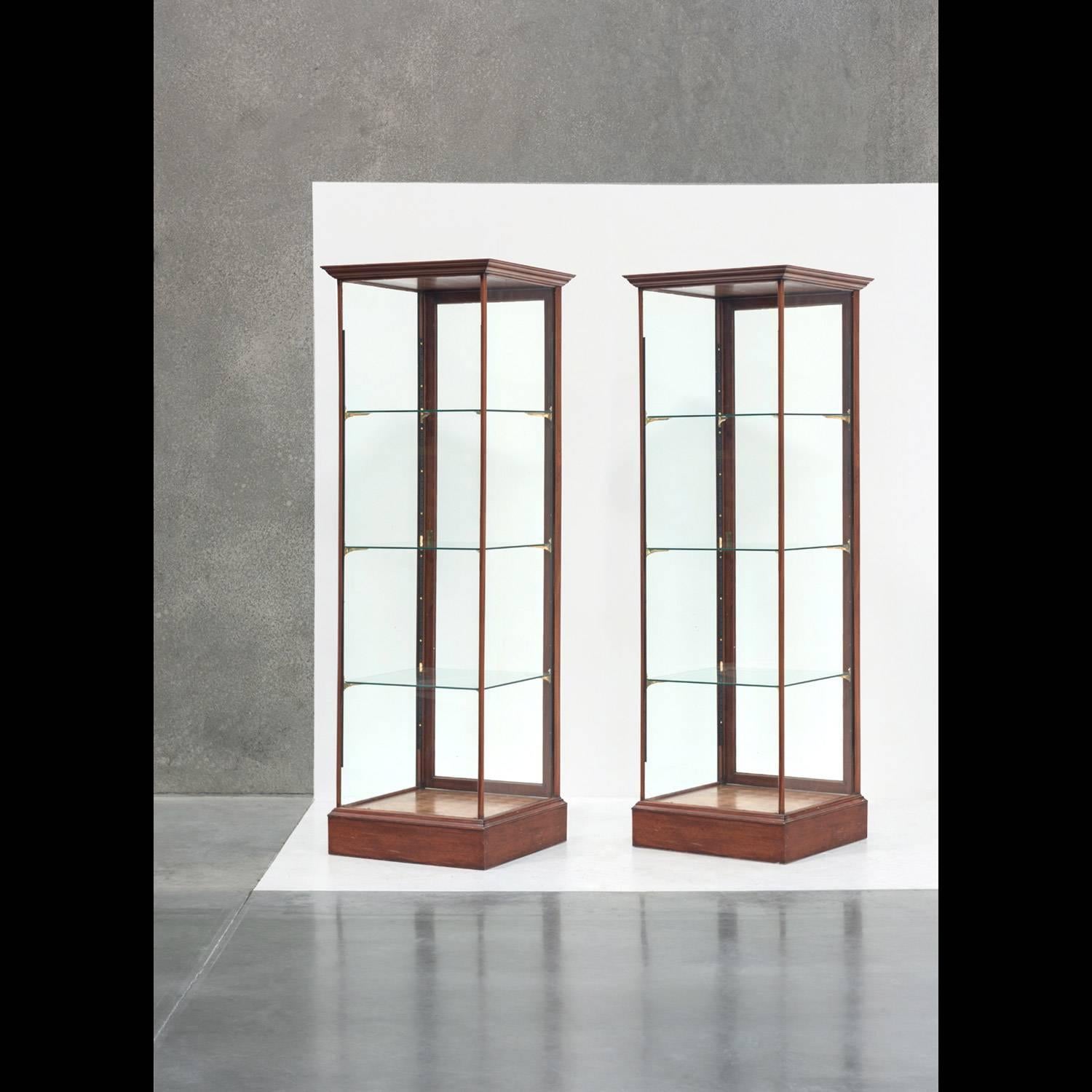 Mahogany Display Tower Unit from England circa 1930.

Identical display cases, constructed from Mahogany. Each unit has a marquetry base, and features original glass with brass and iron supports.