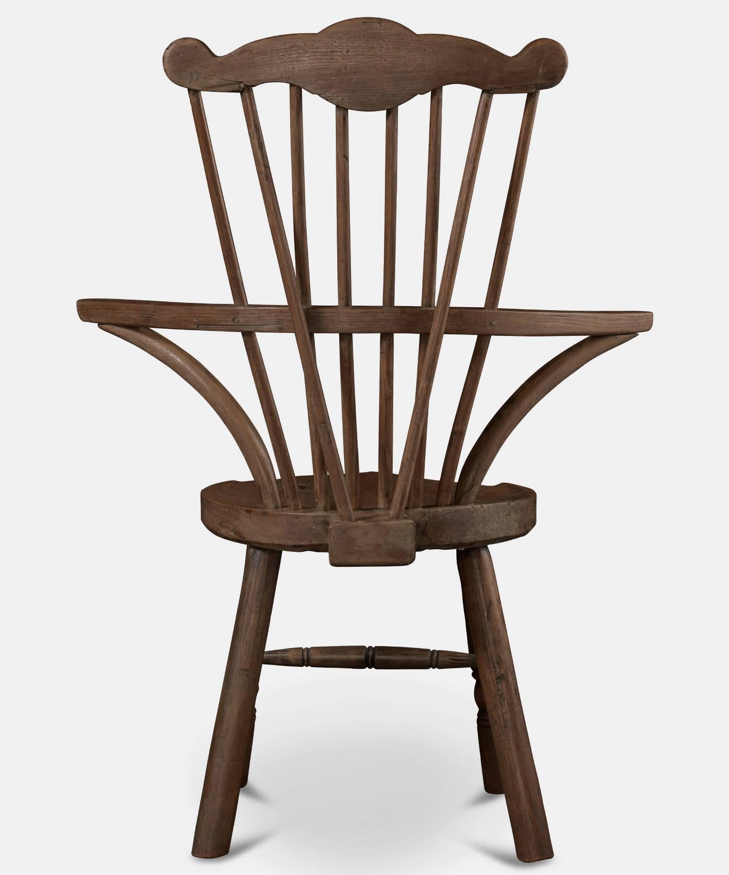 Ash Comb Back Windsor Chair, circa 1760. Made of ash wood. Playful shape and solid construction with circular slab seat. 