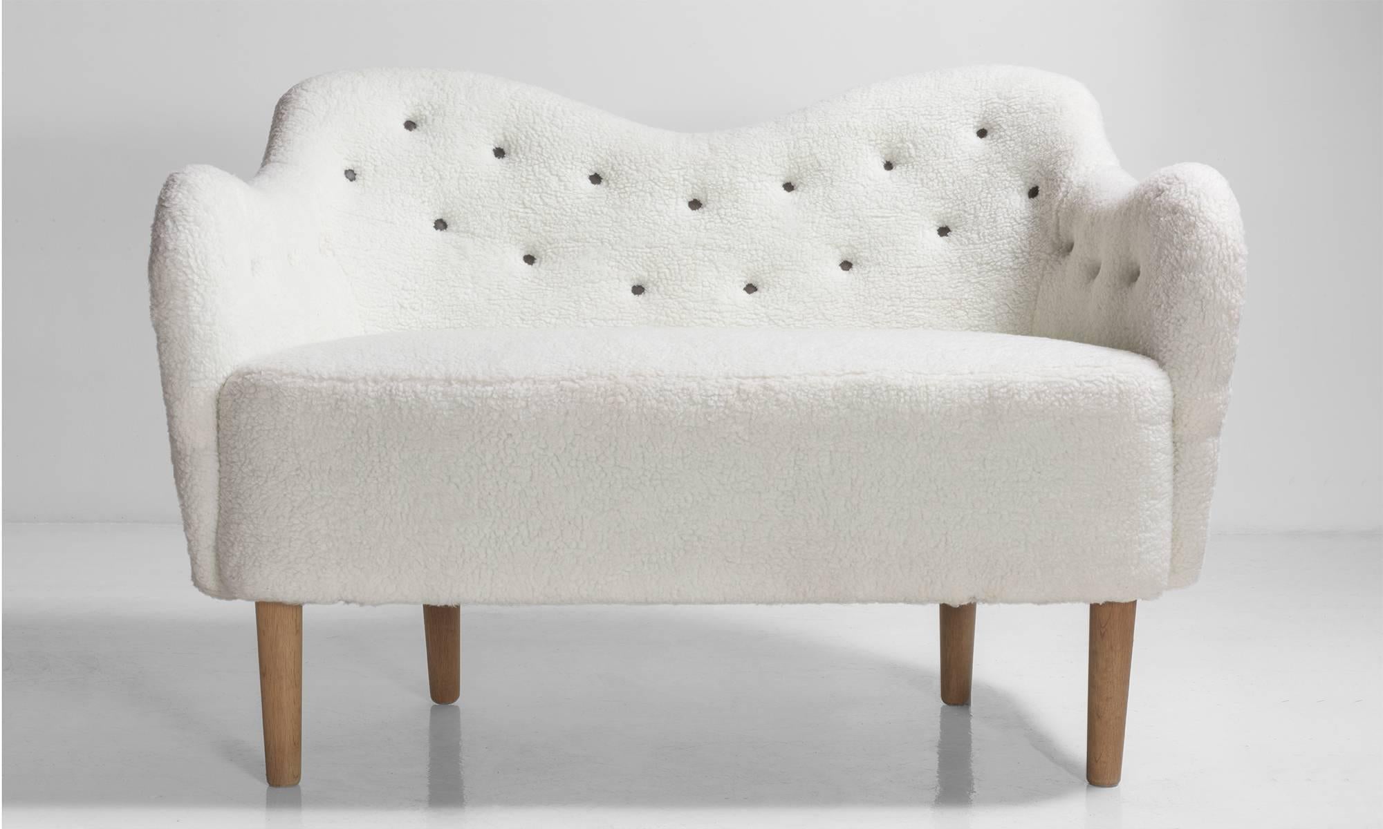 Faux wool Danish sofa, circa 1970.

Danish loveseat with curved back and arms in the style of Finn Juhl. Beautiful form from all sides.
  