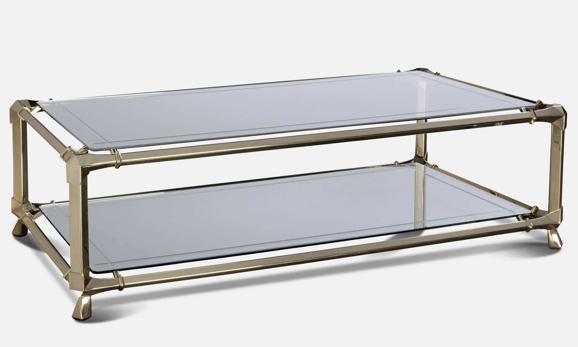 Brass and bevelled glass coffee table.

Italy, circa 1970.

Floating glass top with magazine rack.

Measures: 55" L x 32" D x 16.5" H.