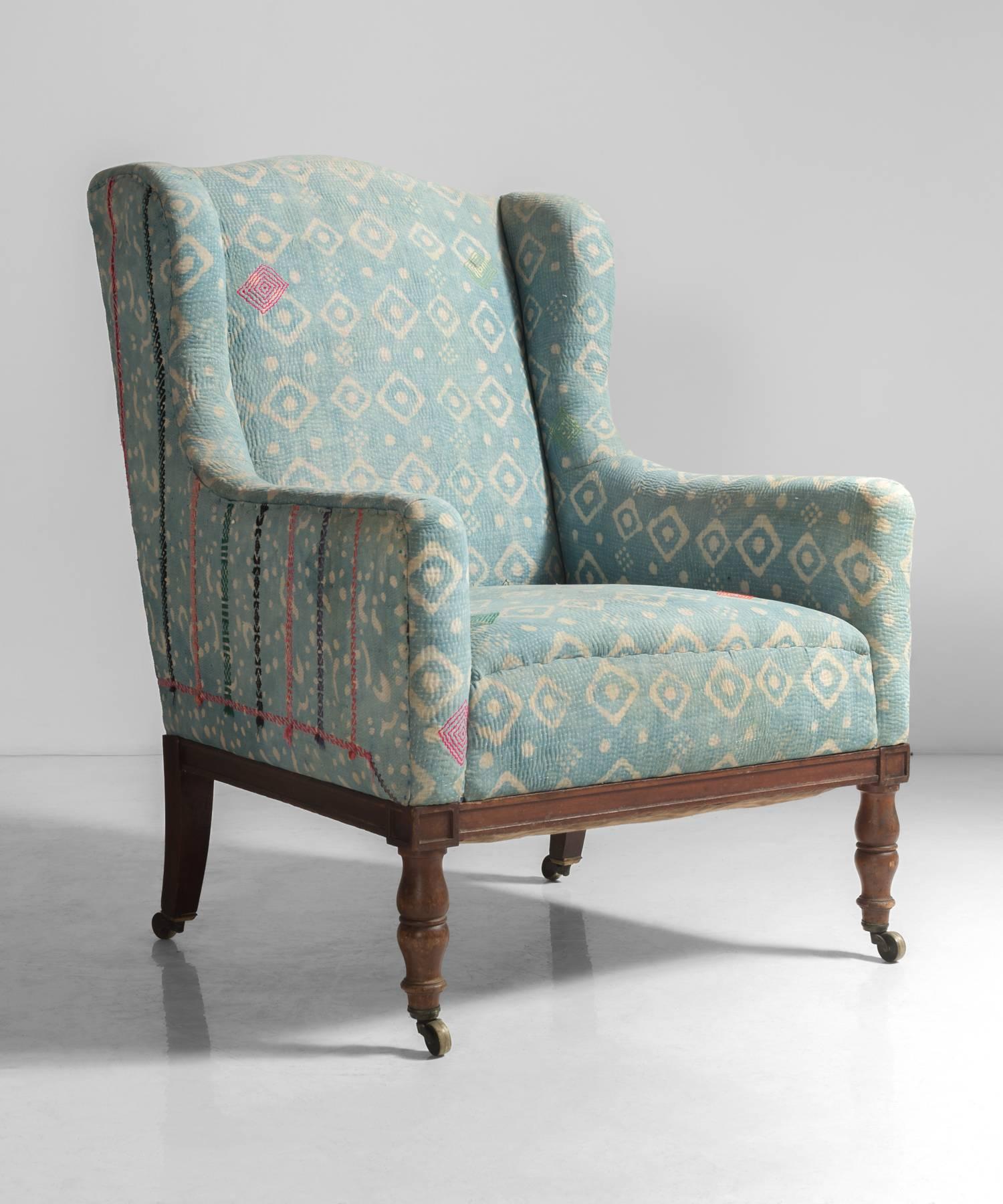 Indian Quilt Walnut Wingchair, England, circa 1880.

Reupholstered in vintage Indian quilts. Walnut frame, with handsome turned legs on original castors.