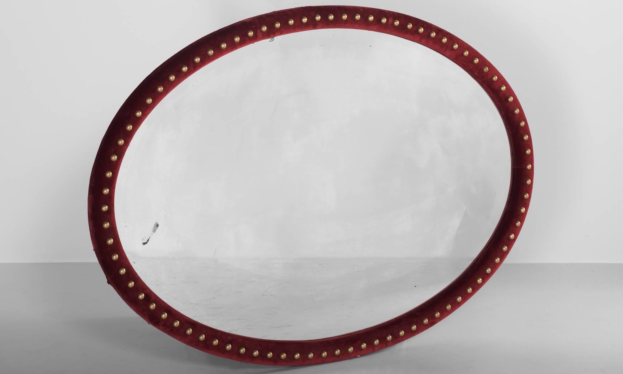 Unusual Victorian mirror with original mercury glass plate and red velvet surround, decorated with brass studs.