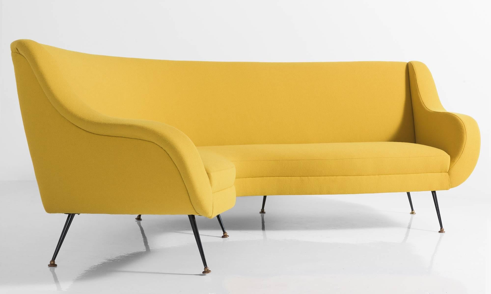 Modern conversational sofa with painted black metal feet. Newly reupholstered in yellow Maharam wool fabric. Incredible form.