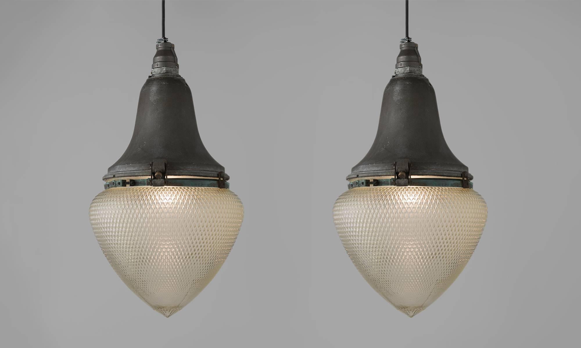 Industrial aluminum and glass street lamps, circa 1930.

Elegant shaped aluminum mount with original patterned and textured glass shade.