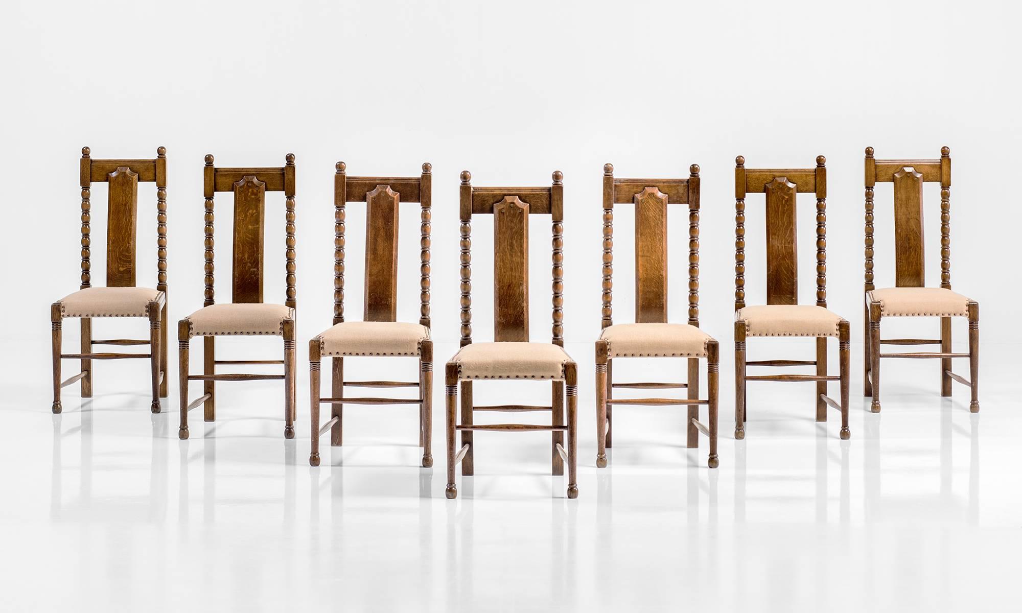 Oak dining chairs, with incredibly detailed construction, upholstery in Hessian burlap.
  