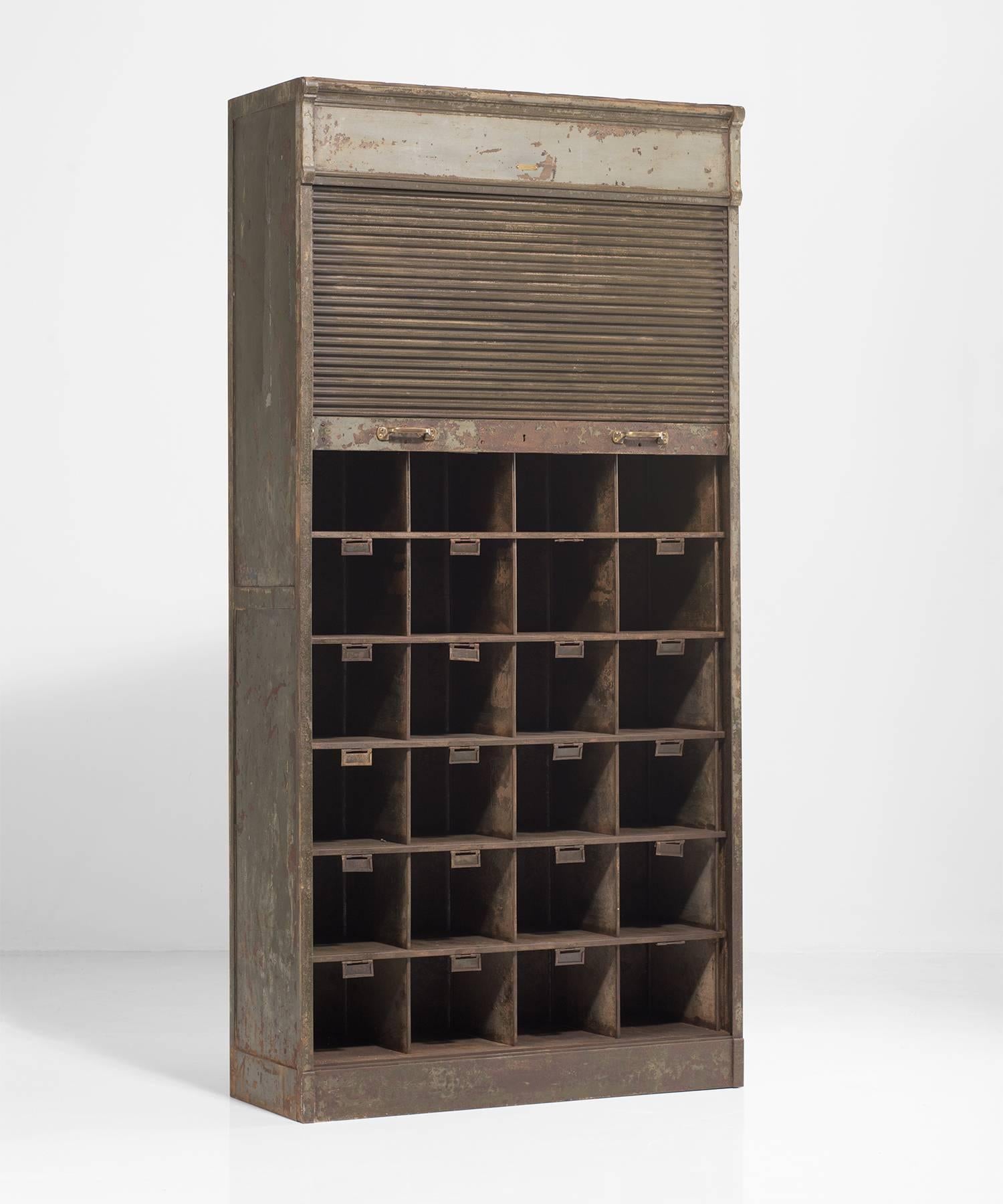 Industrial roller cabinet by Strafers, circa 1930.

Metal cabinet with original green paint and identical square compartments.