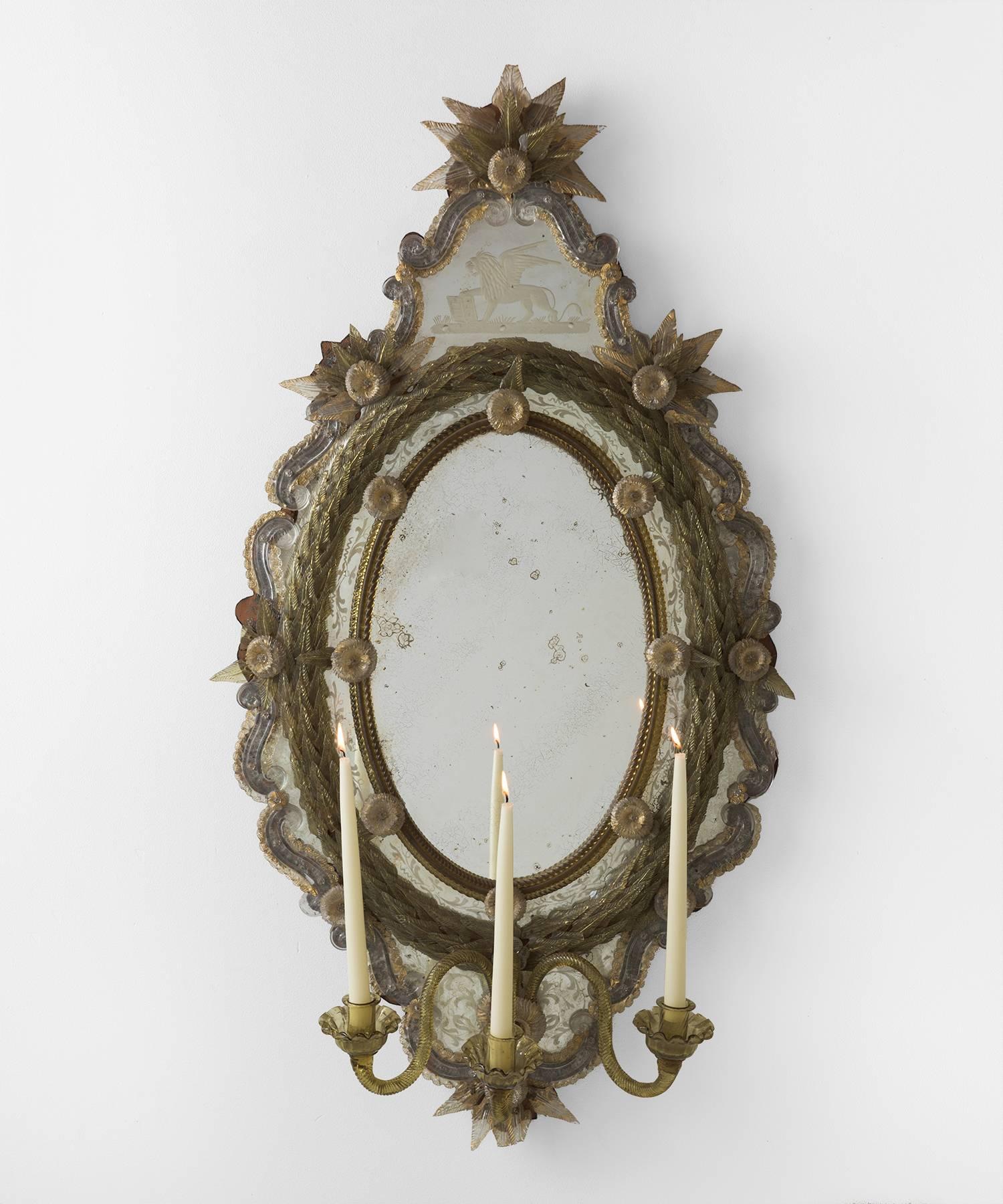 Ornate Venetian Murano glass mirror, circa 1810.

Incredibly ornate mirror of Murano glass with intricate details, amazing patina, and a trio of candleholders.
 